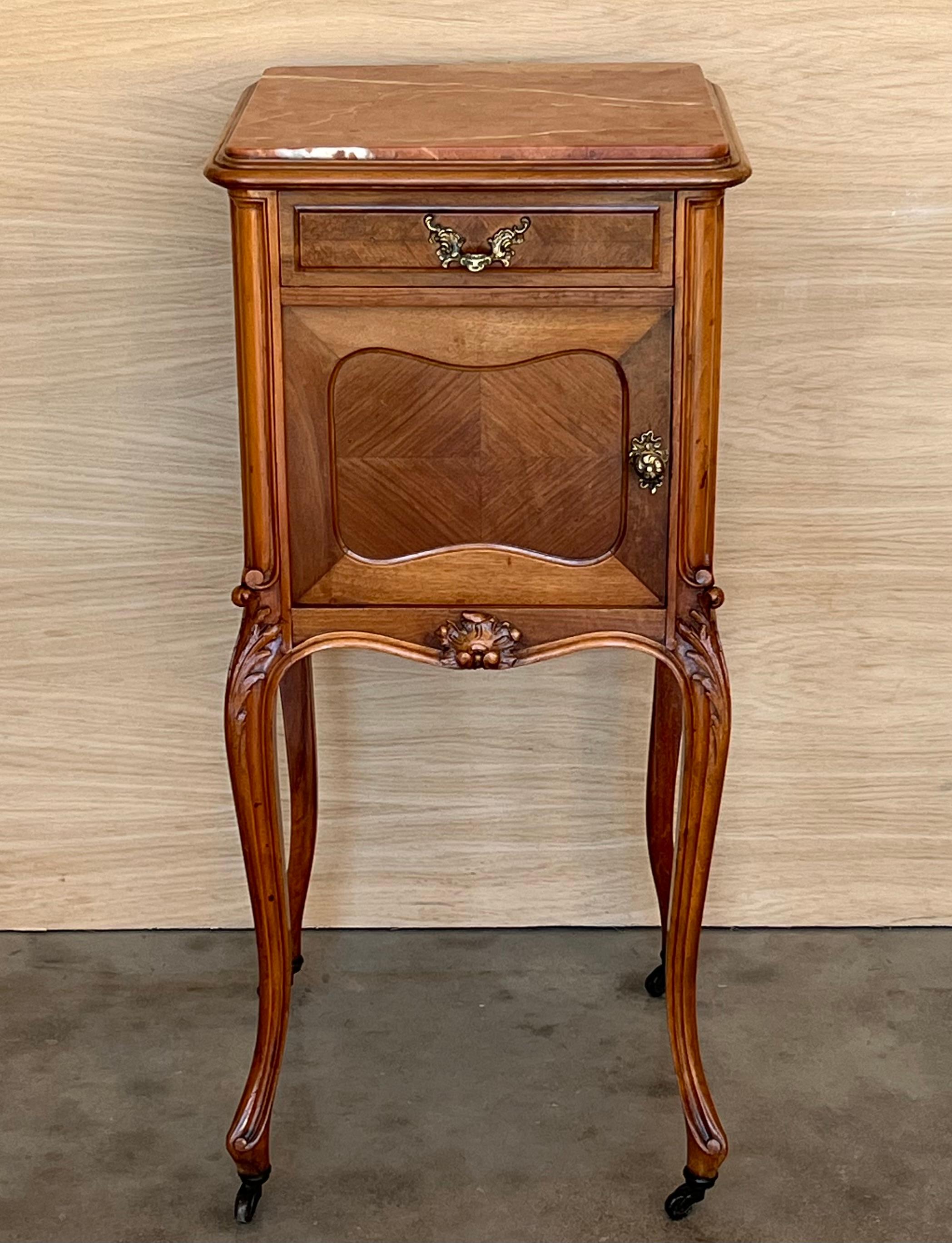 Two very nice elegant France nightstands. White marble tops on brass wheels. The interior compartment was made of white marble. Bronze handles. Walnut wood.