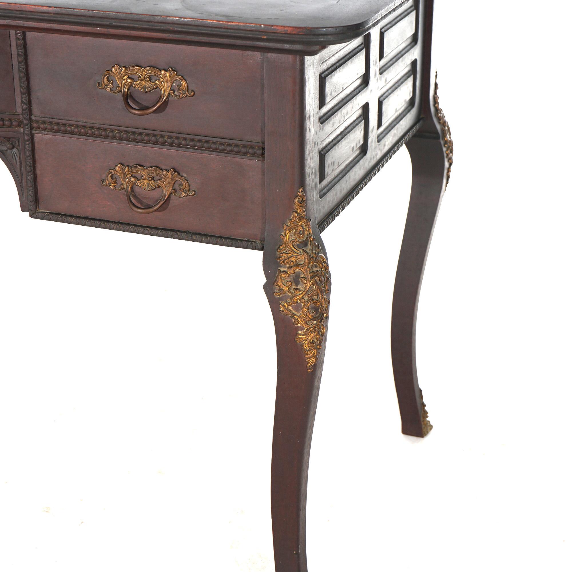 An antique French bureau plat writing desk offers shaped mahogany construction with paneled case with drawers, foliate cast ormolu mounts and raised on cabriole legs, c1910

Measures - 29.5