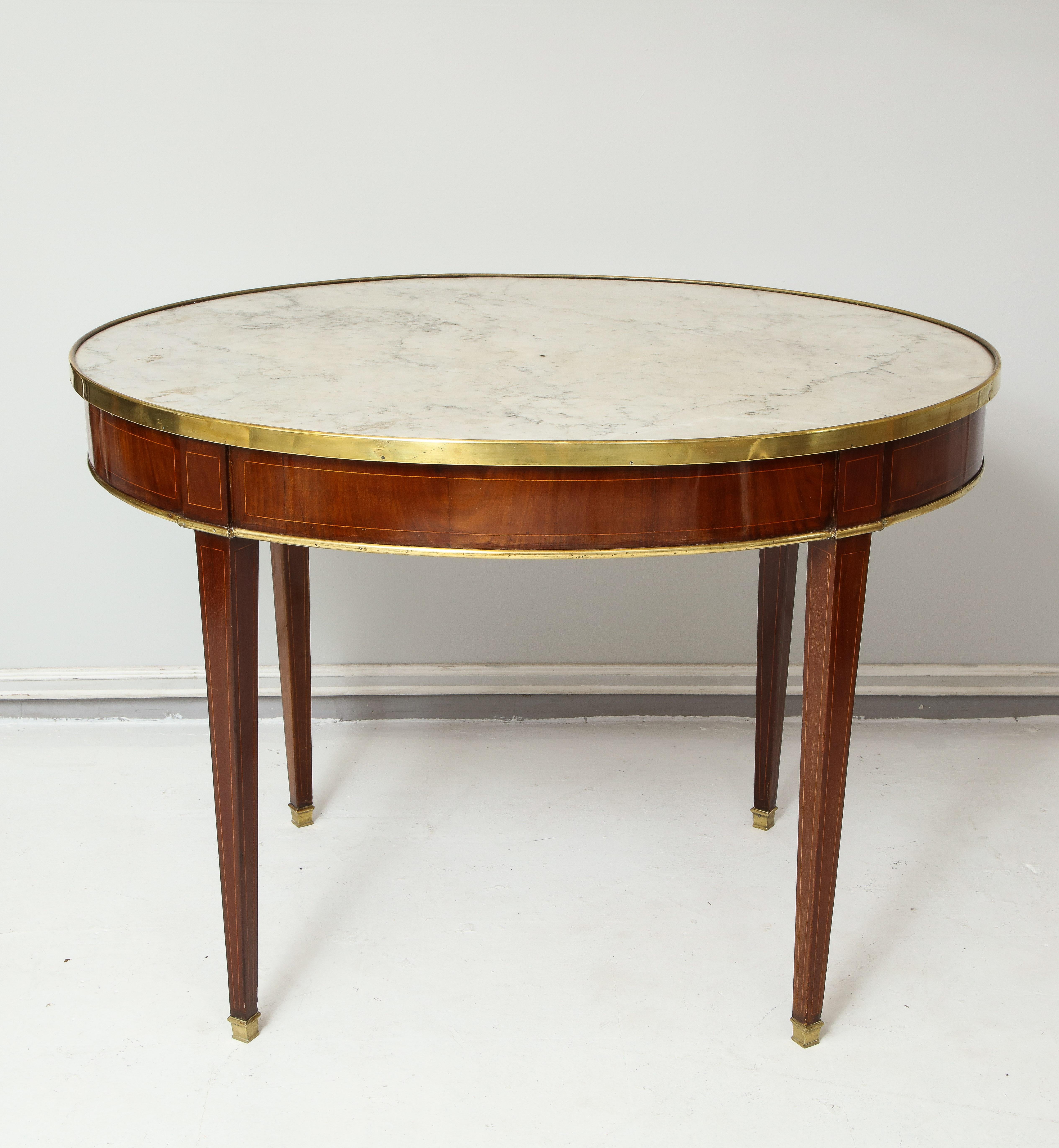 Antique French mahogany oval marble-top bronze-mounted bouillote table on tapered legs.
