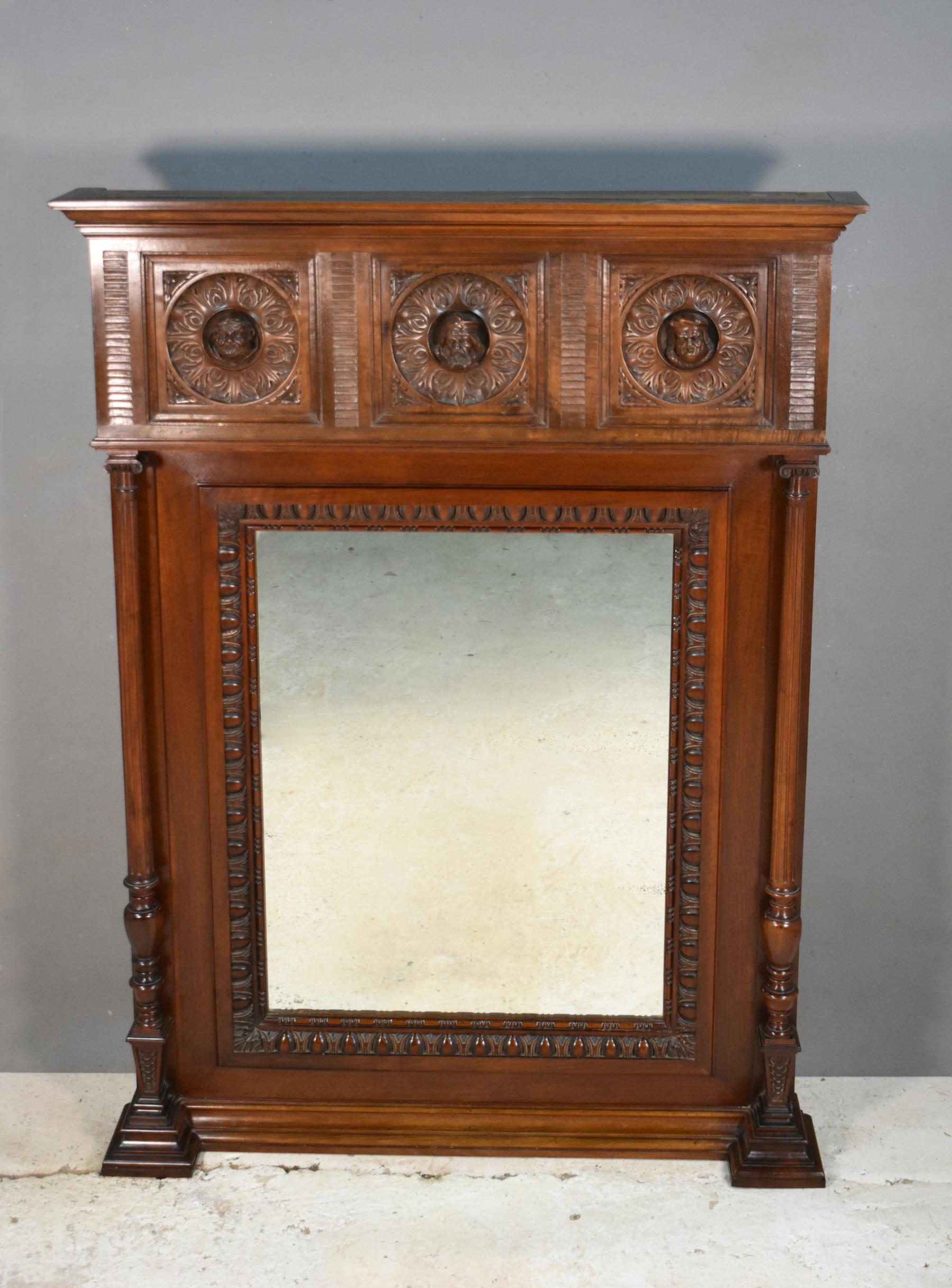 Unique French Mahogany Henri II overmantel mirror 

This outstanding quality mirror features three beautifully carved heads surrounded by floral motifs. 

Flanking each side are turned tapering fluted columns. 

The mirror is enclosed within