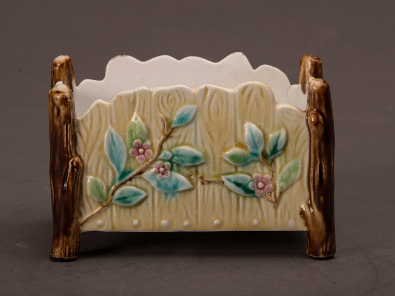 A charming antique French Majolica Barbotine ware glazed ceramic cachepot garden flower pot from France, circa 1890. This tabletop container for a small plant is rectangular in shape and finished on all four sides. The complementary colors and