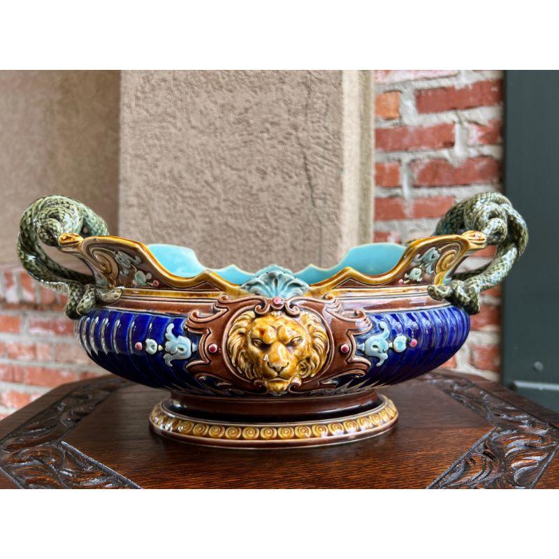Antique French Majolica Cache Pot Planter Jardiniere Sarreguemines Snake Handle & Lions.

Direct from Sarreguemines, France, a gorgeous, authentic French majolica jardiniere. The beautiful silhouette features a shaped bowl with intertwined snake