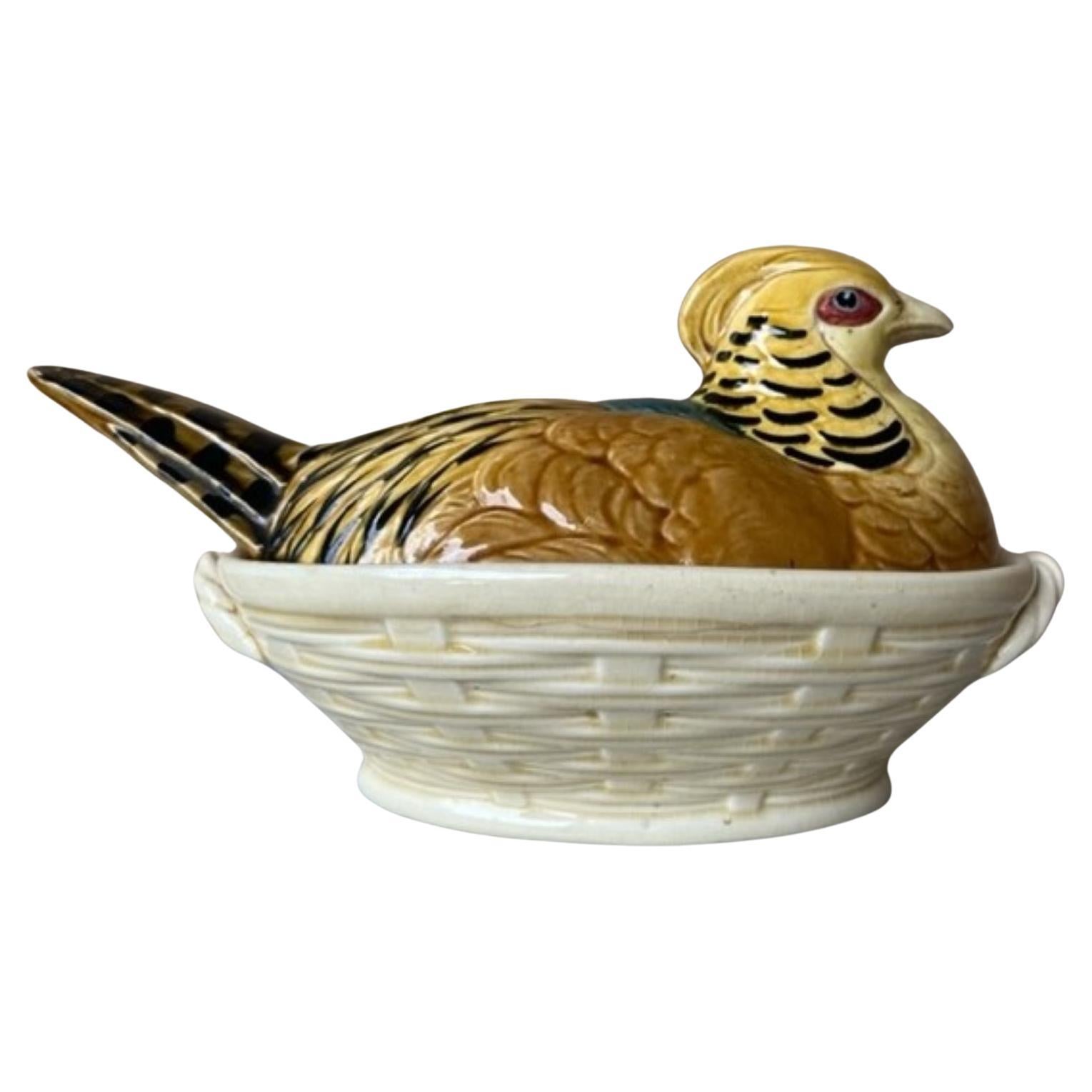Brightly colored French majolica tureen of a pheasant hen on a basket by Sarreguemines, made in the late 19th to early 20th century.

Sarreguemines France & K are stamped on the bottom.