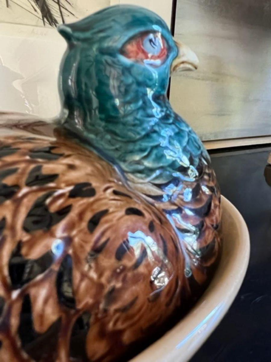 Brightly colored French majolica tureen of a pheasant hen on a basket by Sarreguemines, made in the late 19th to early 20th century.

Mold on the inside 4451 as well as French cursive. Sarreguemines 227 A is stamped on the bottom.