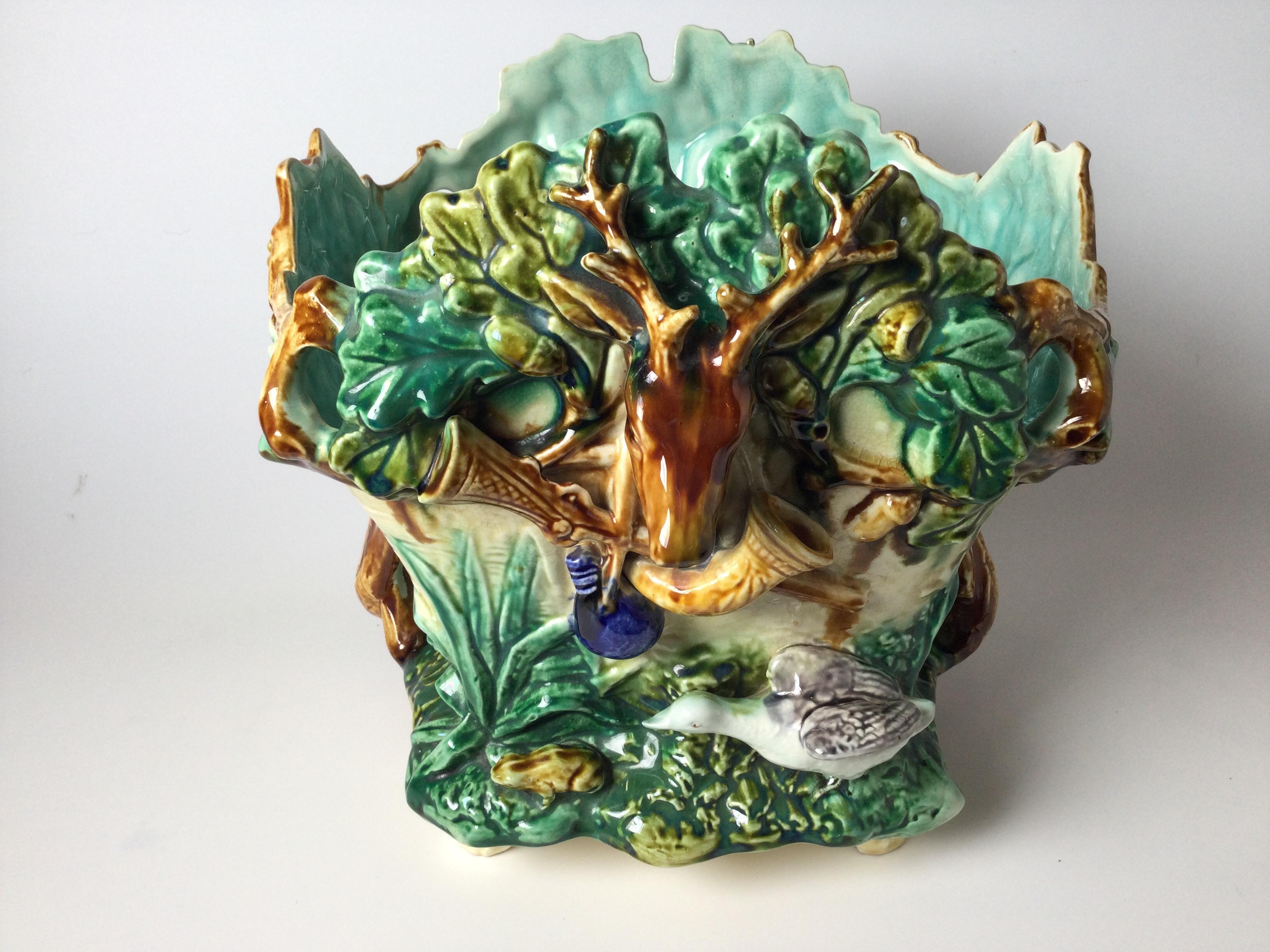 Vibrant antique jardinière with leaves and branches with a stag at the fron, late 19th century France.