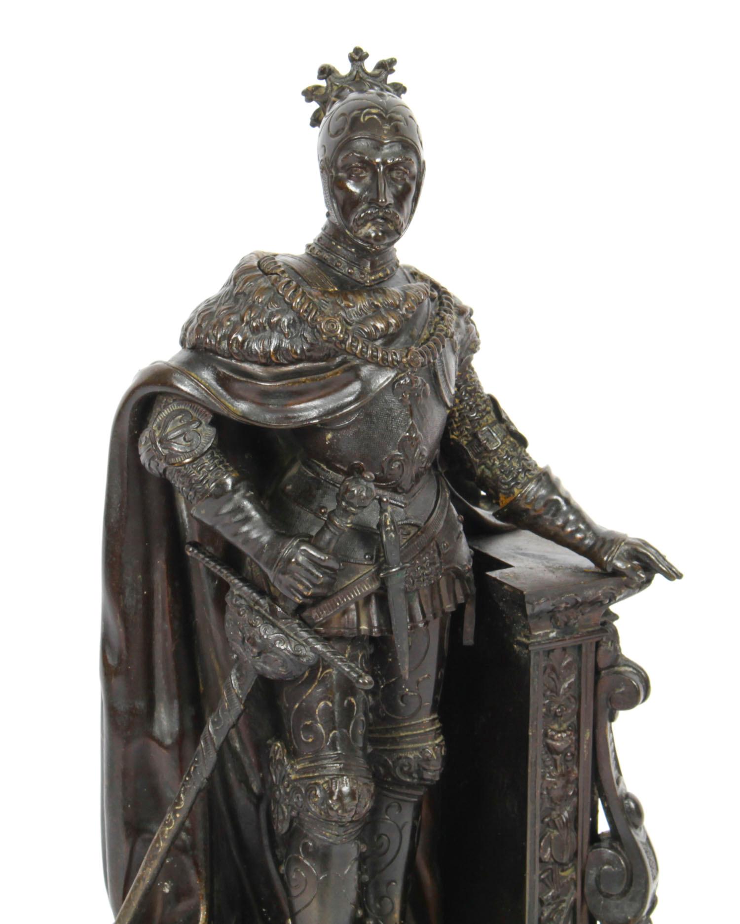 This is a wonderful antique French bronze and malachite sculpture of a warrior, Circa 1850 in date.
 
The finely cast dark brown patinated bronze figure depicts a knight in armour with sword, the top of his helmet adorned with a crown.

The