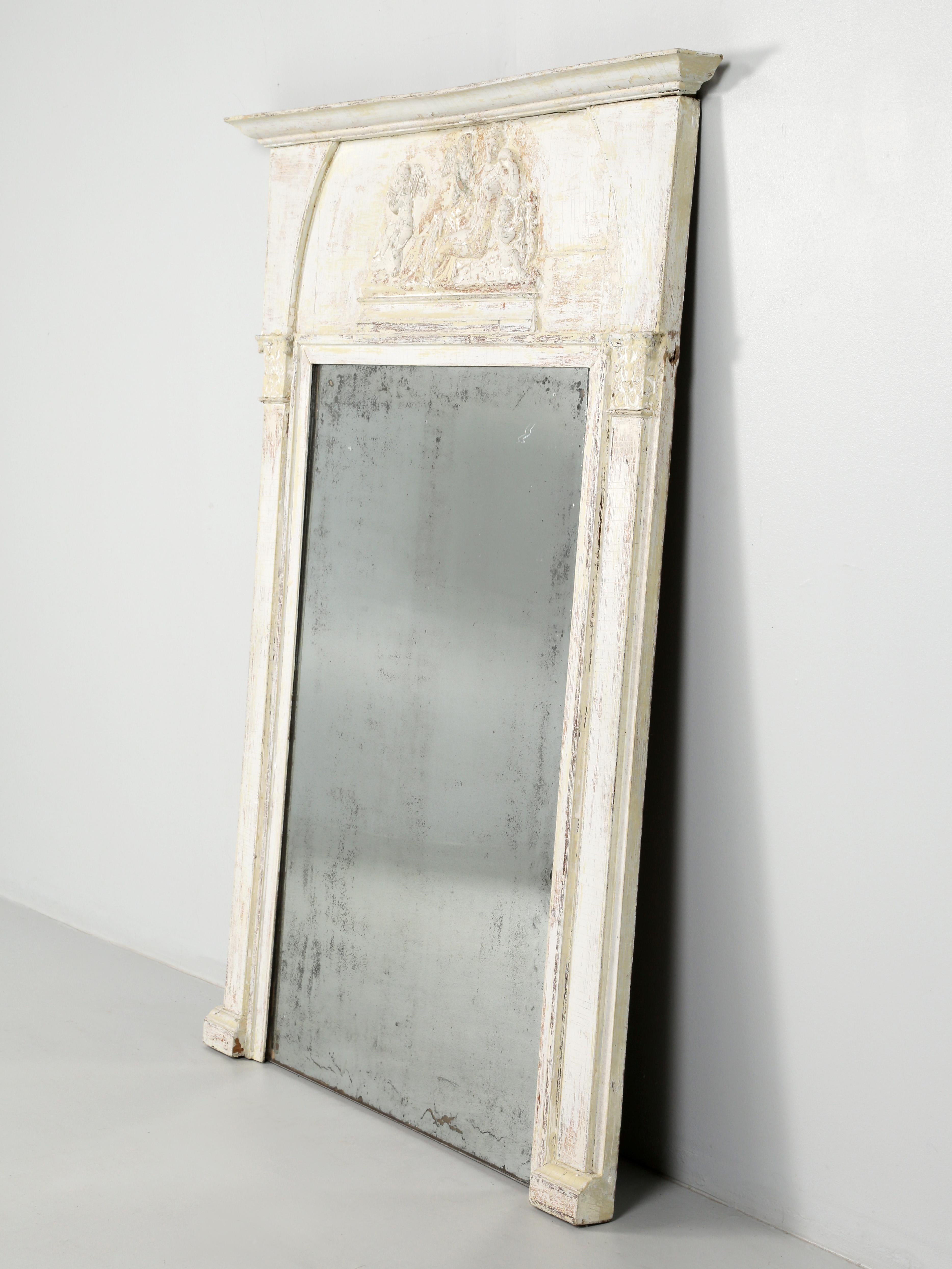 Antique French painted Trumeau mirror, which originated as a center pillar covered with a mirror supporting a large doorway. By the 1800's in France, the Trumeau mirrors became an over-mantle decoration above a fireplace. Our antique French trumeau