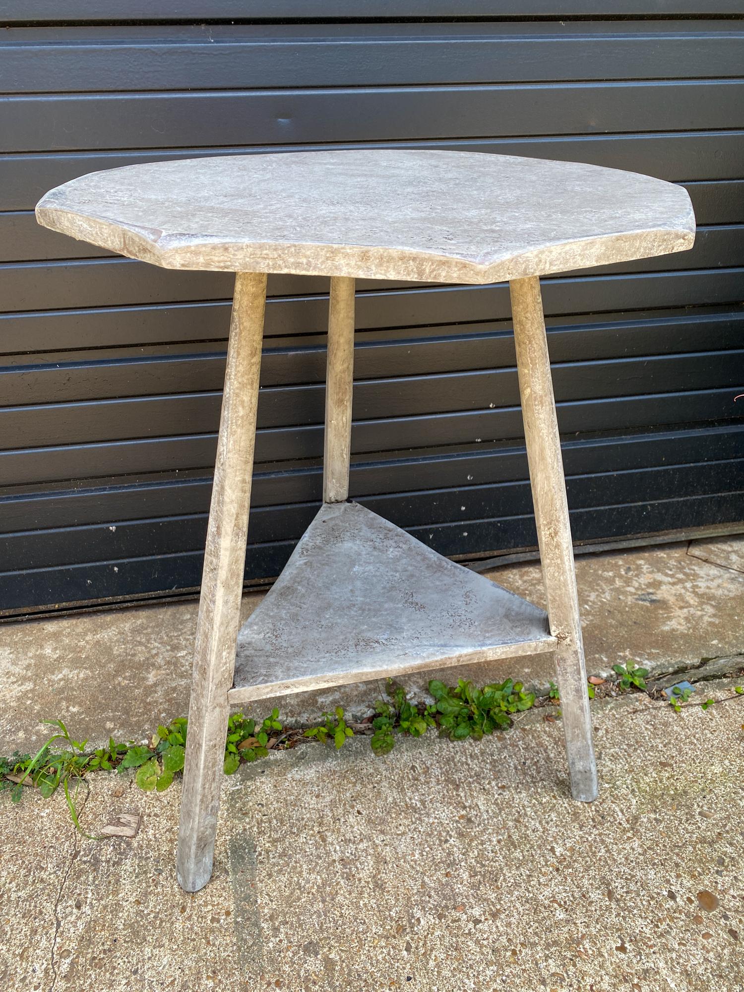 This is an antique French maple cricket table in a newly hand painted greige finish. The top is octagonal (typically cricket tables are made with a round top, so this is more unique) and the under tier is triangular, set between the legs. The lines
