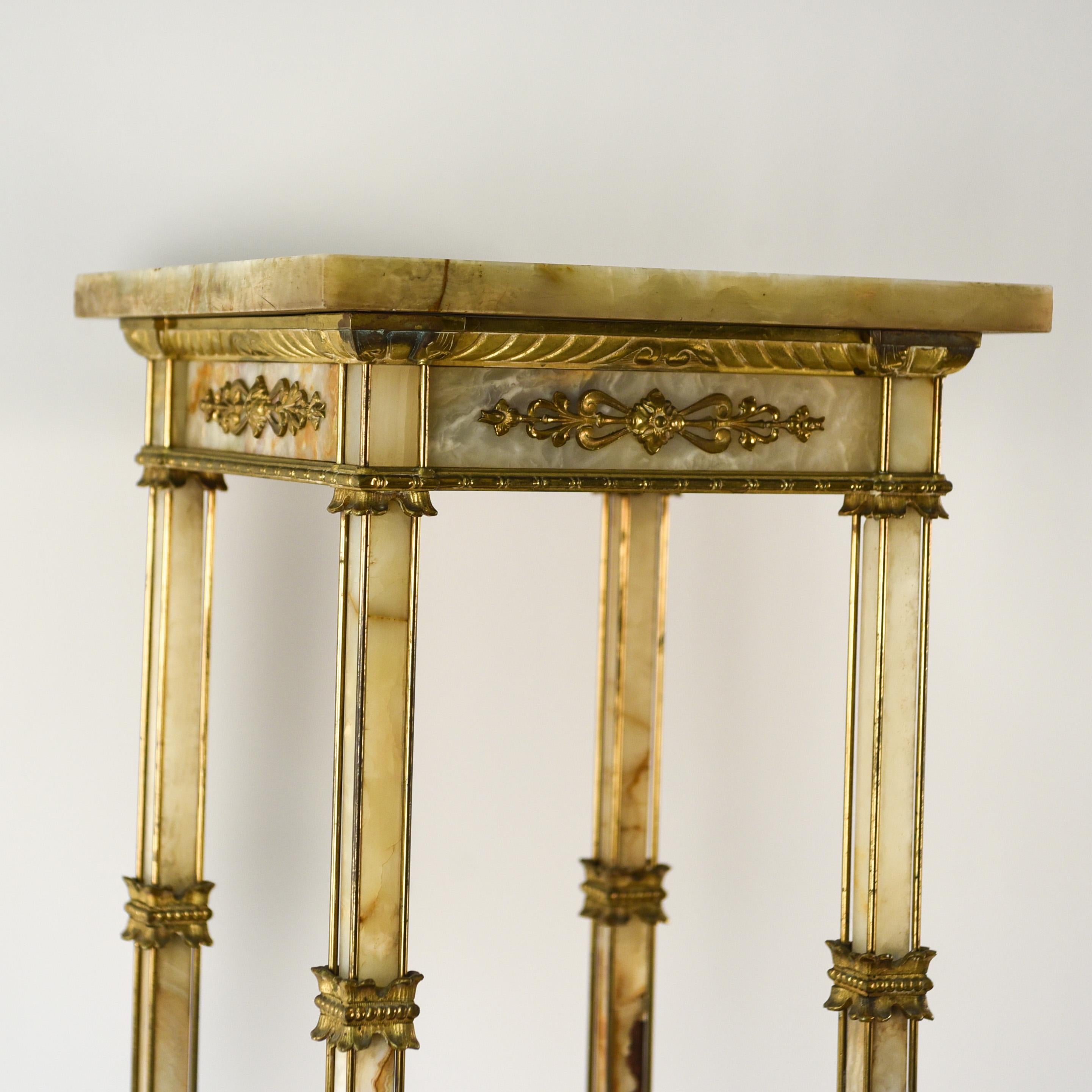 This antique ornate brass and marble pedestal provides a wonderful stand to place a special piece upon. With beautiful brass ornaments, this pedestal can also stand alone as a decorative piece in an interior.