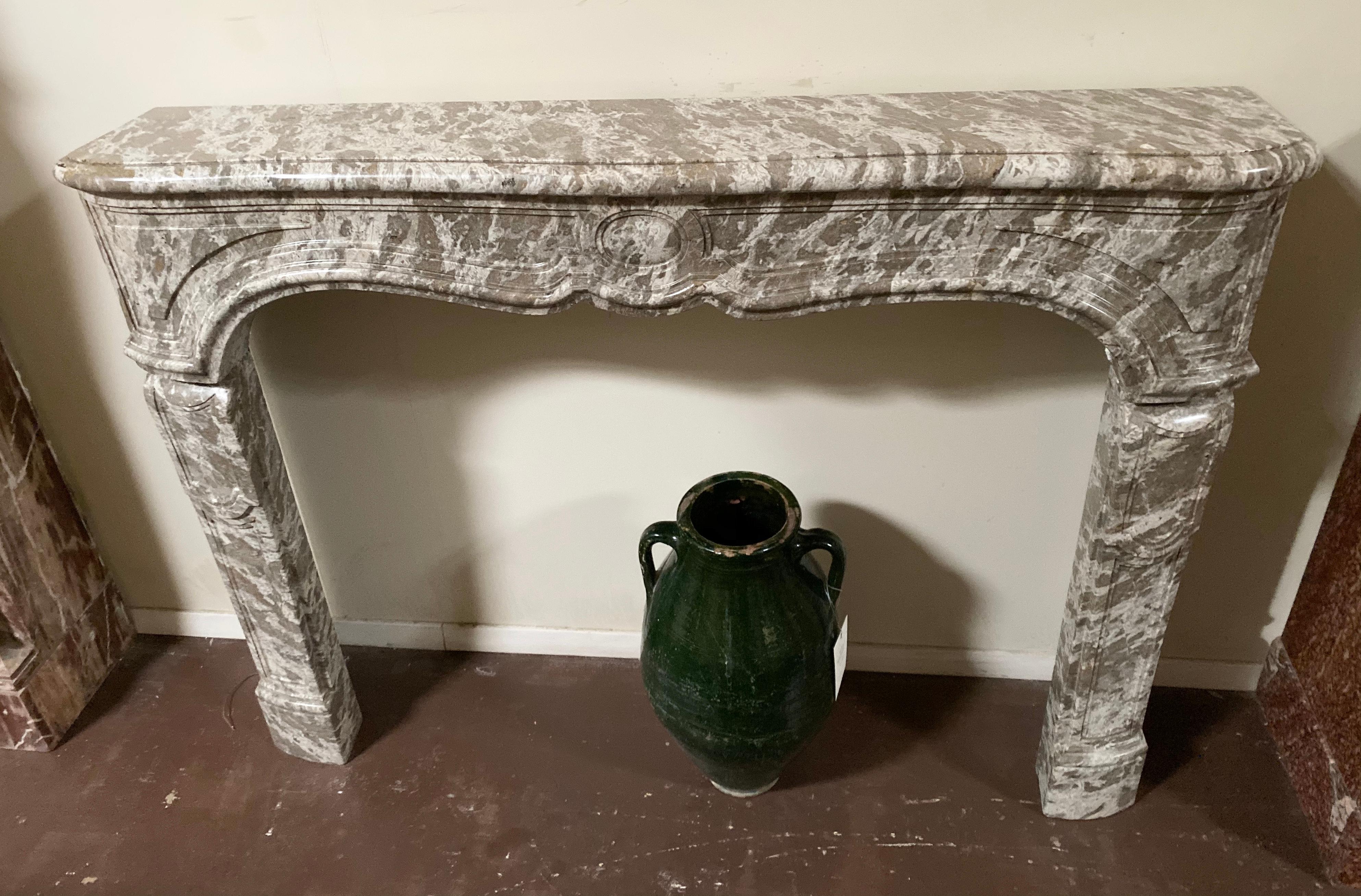 This Louis XV marble mantel features grey and white coloring and originates from France, circa 1740.

Measurements: 
57.5