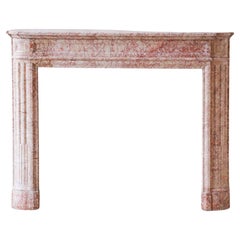 Antique French marble fireplace in pink tones