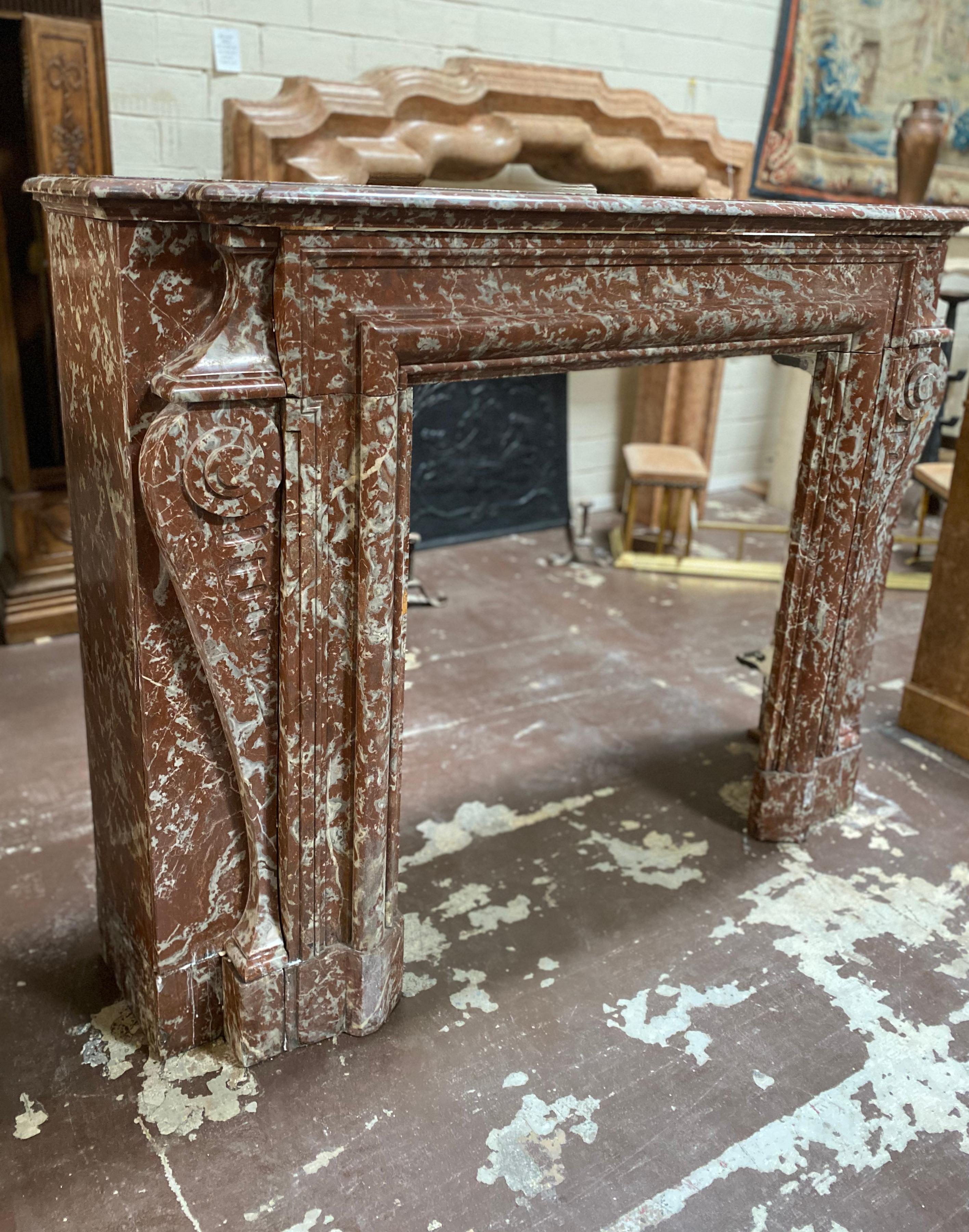 This warm hued marble mantel originates from France, circa 1800. Its flawless condition features detailed carving and flecks of grey and white.

Measurements: 15