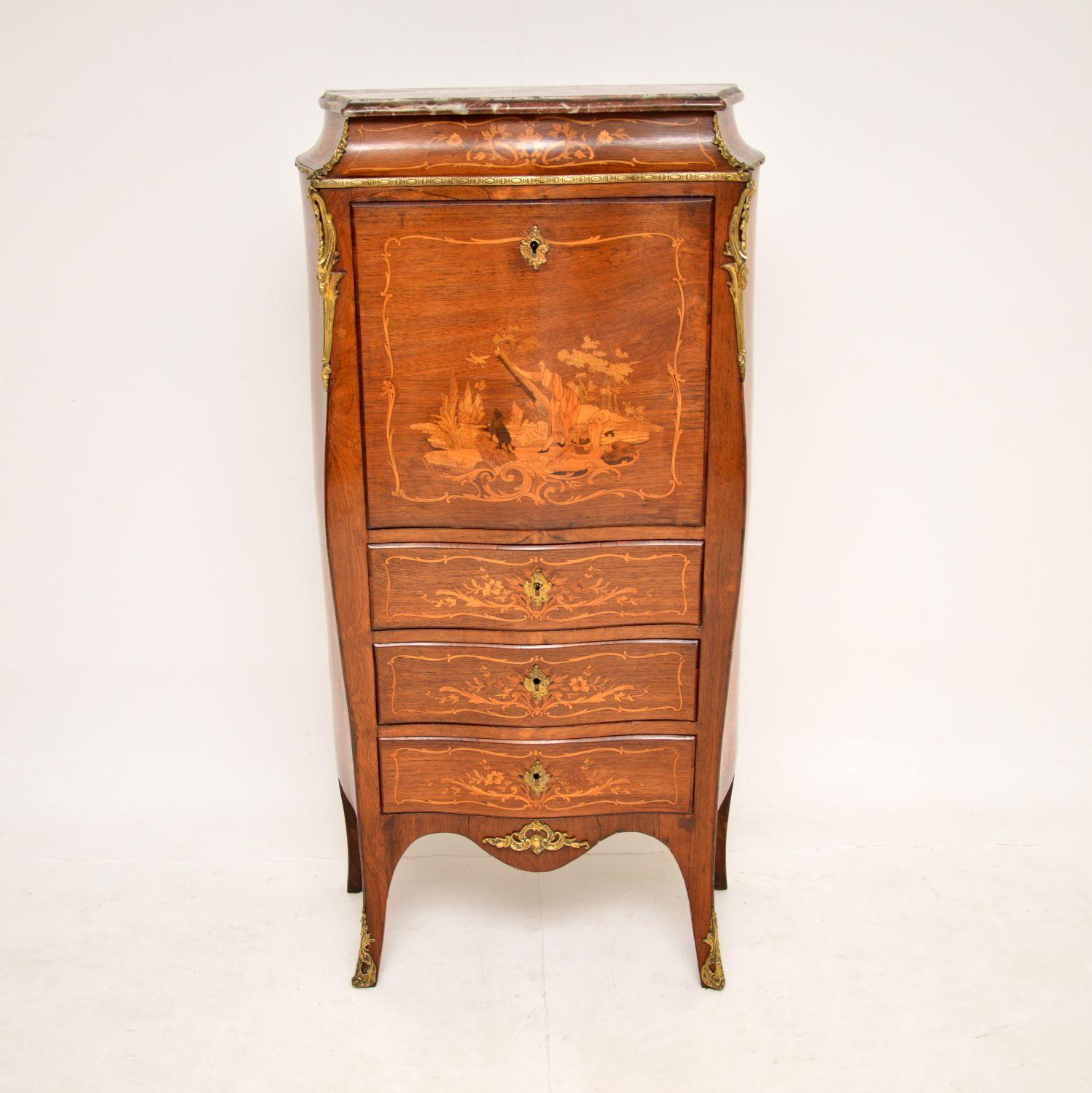 A stunning antique bombe shaped French secretaire chest with an original rouge marble top and pull down writing surface. This was made in France and dates from around the 1890-1900 period.

It is of amazing quality, and has gorgeous patterns