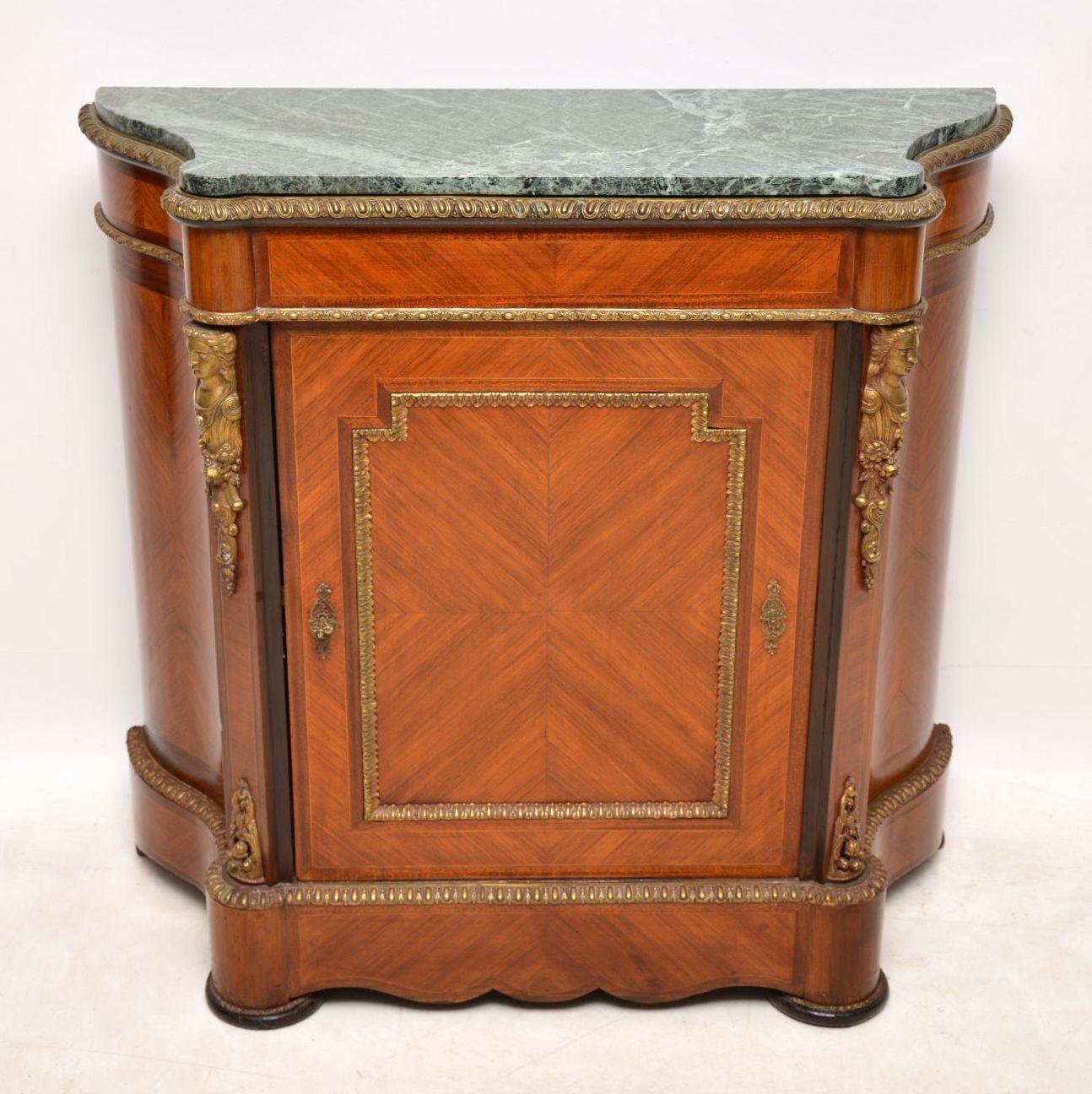 Antique French marble top cabinet in kingwood with some very decorative gilt bronze mounts. It has one central panelled door and serpentine shaped sides. The marble top is original & in good condition too. There’s one shelf inside, plus a lock & key