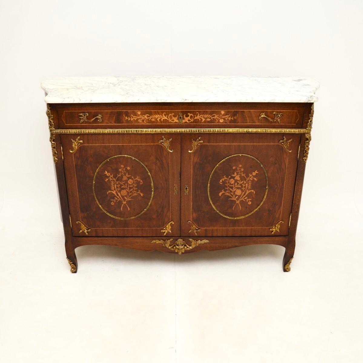 Un bellissimo e imponente mobile antico francese con piano in marmo, risalente agli anni '30 circa.

È estremamente ben fatto e dotato di molte caratteristiche di pregio. La carcassa presenta splendidi intarsi floreali in legno di raso. Ci sono
