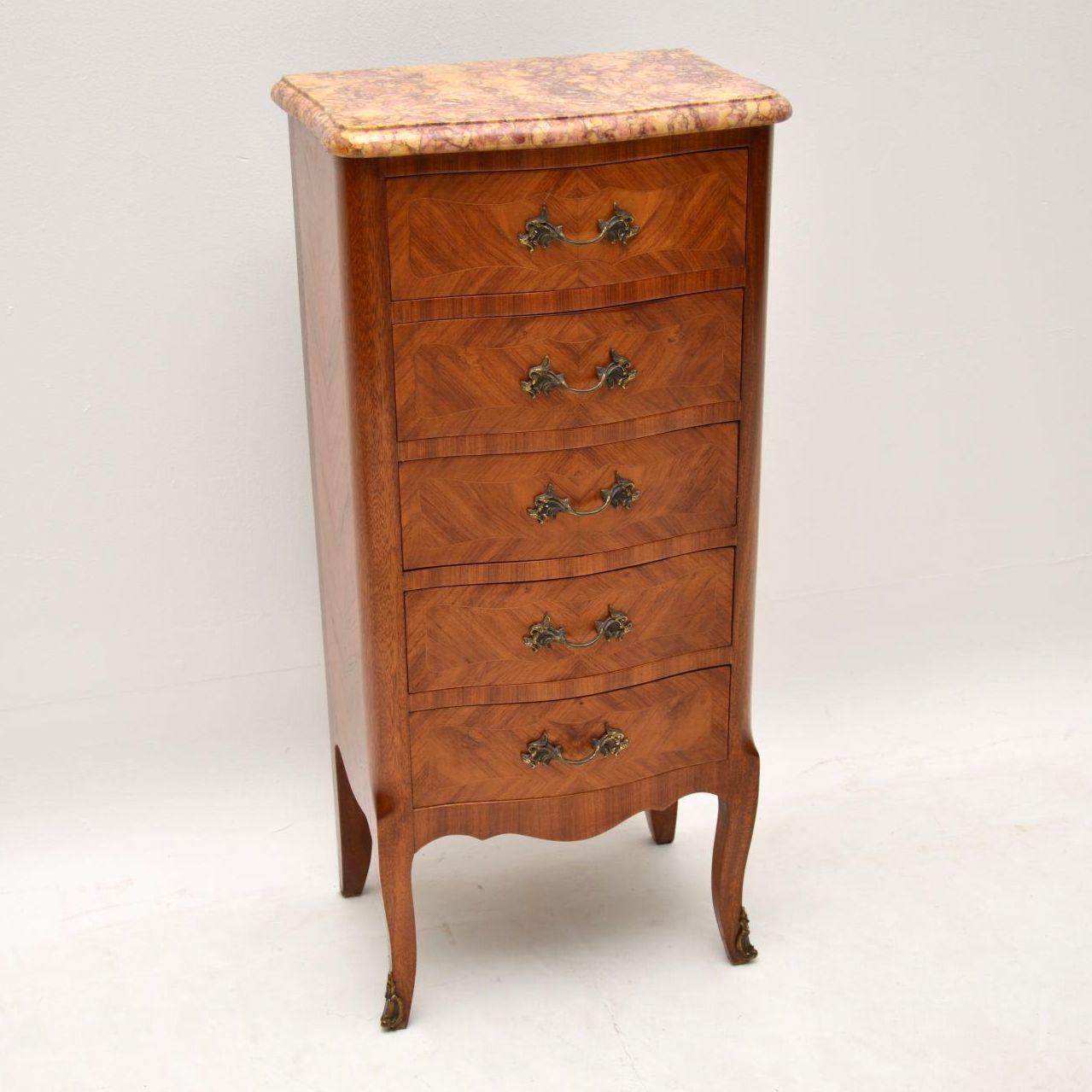 Small slim serpentine shaped antique French Kingwood marble top chest of drawers in excellent condition, which I would date to around the 1920s-1930s period. The drawers are all cross banded and inlaid, with original gilt handles and it has gilt