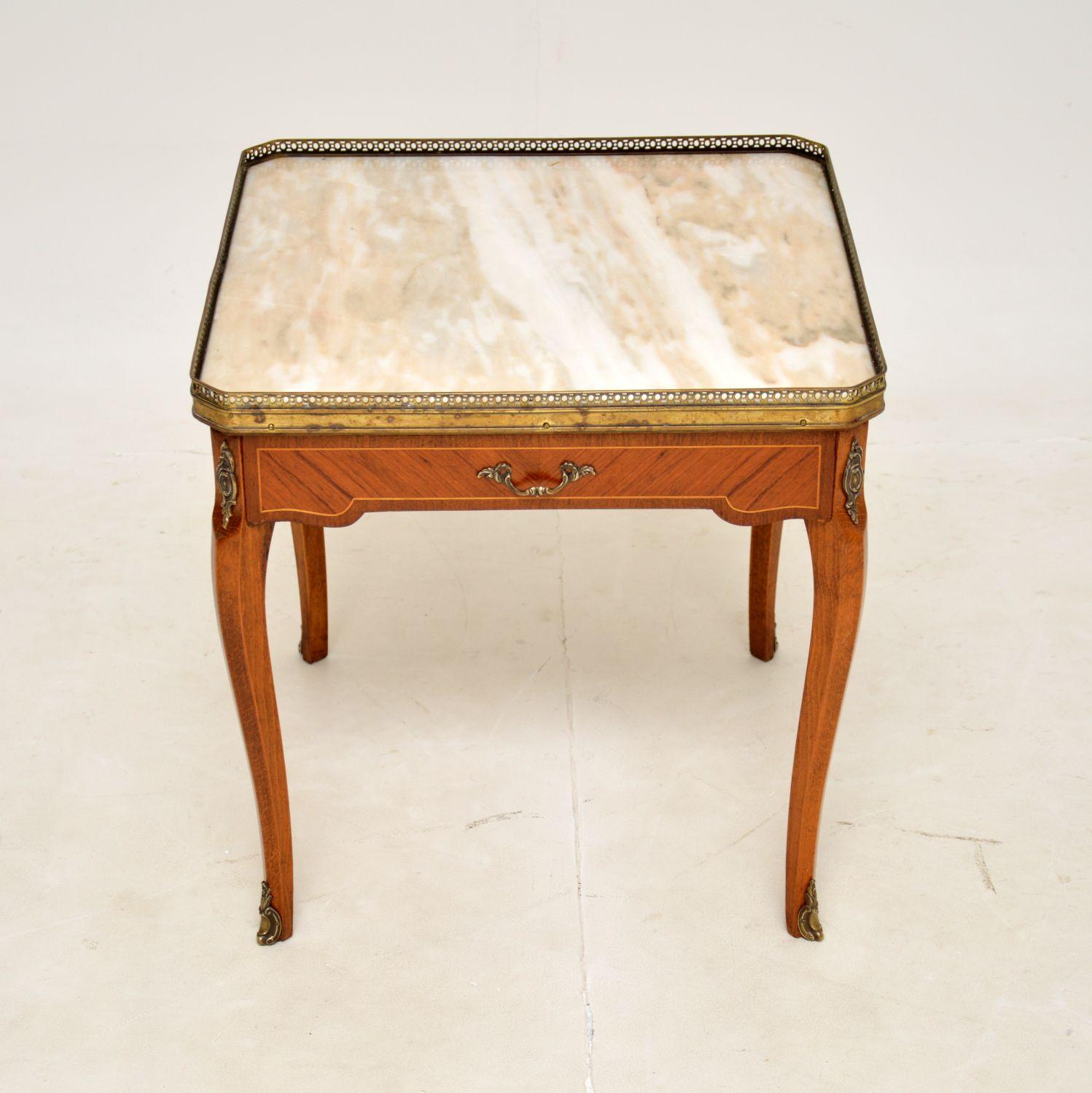 A beautiful antique French marble top coffee table, this dates from around the 1930’s.

It is of super quality, and is a great size to be used as a coffee table or an occasional side table. The marble top has a pierced brass gallery around the edge,