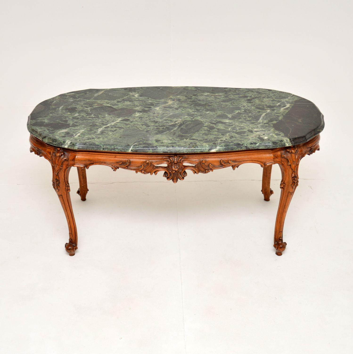 A superb antique French coffee table in carved solid walnut with a marble top. This was made in France and dates from around the 1920-30’s.

It is of outstanding quality, with stunning intricate carving throughout the base. The green marble top has