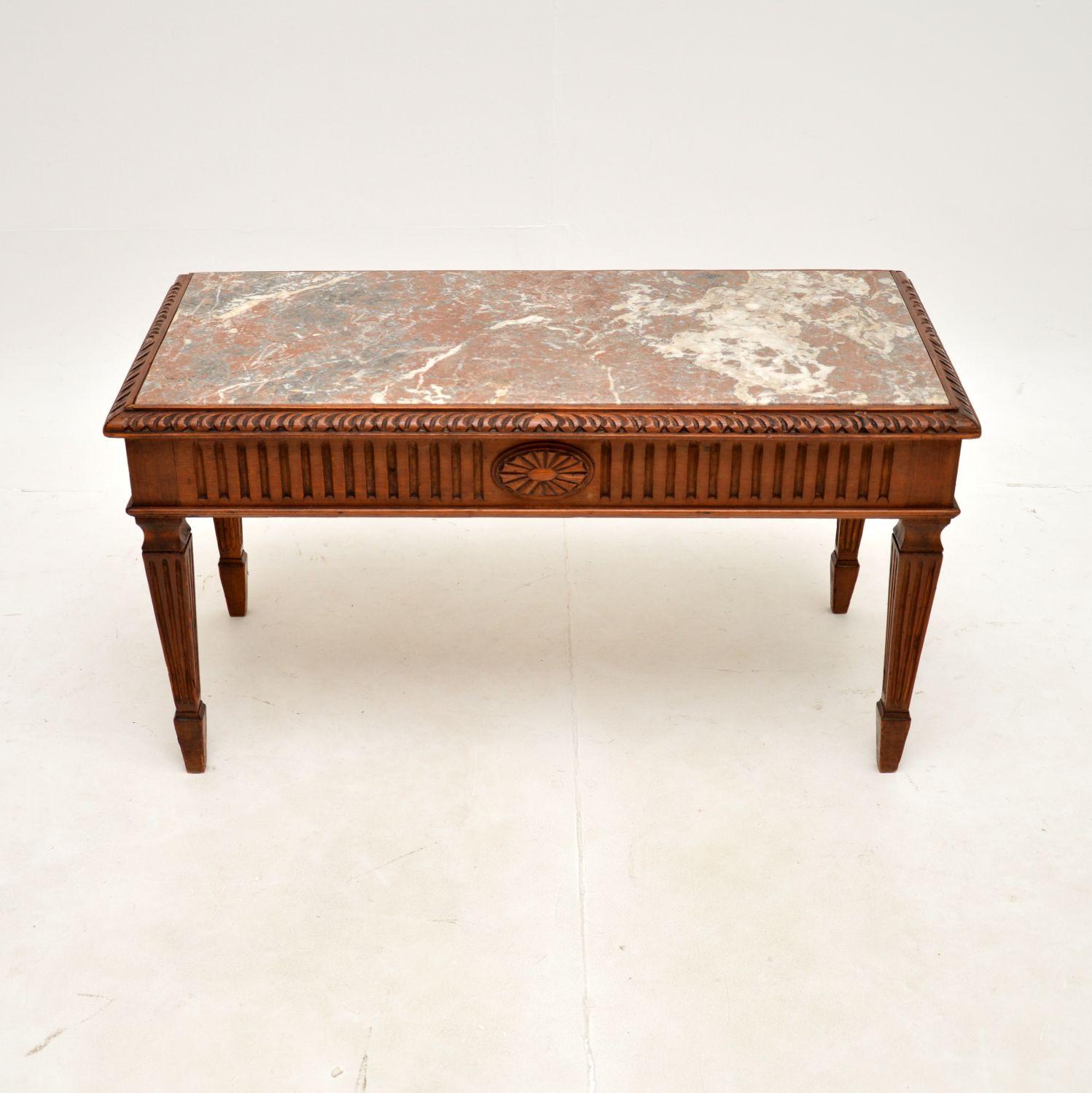 A beautiful antique French marble top coffee table in carved pine. This was made in England, it dates from around the 1900-1910 period.

The quality is outstanding, the solid pine frame is beautifully carved, sturdy and sound, with a gorgeous