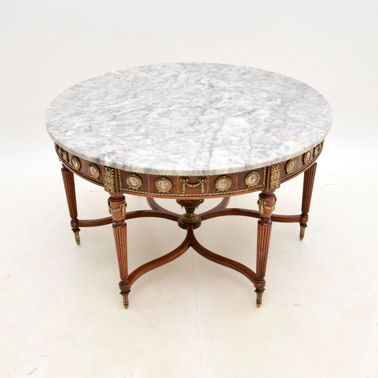 A beautiful and impressive antique French marble top coffee table. This was made in France, it dates from around the 1930’s.

The quality is superb, the frame is made from solid birch and walnut. There are very high quality gilt metal ormolu mounts
