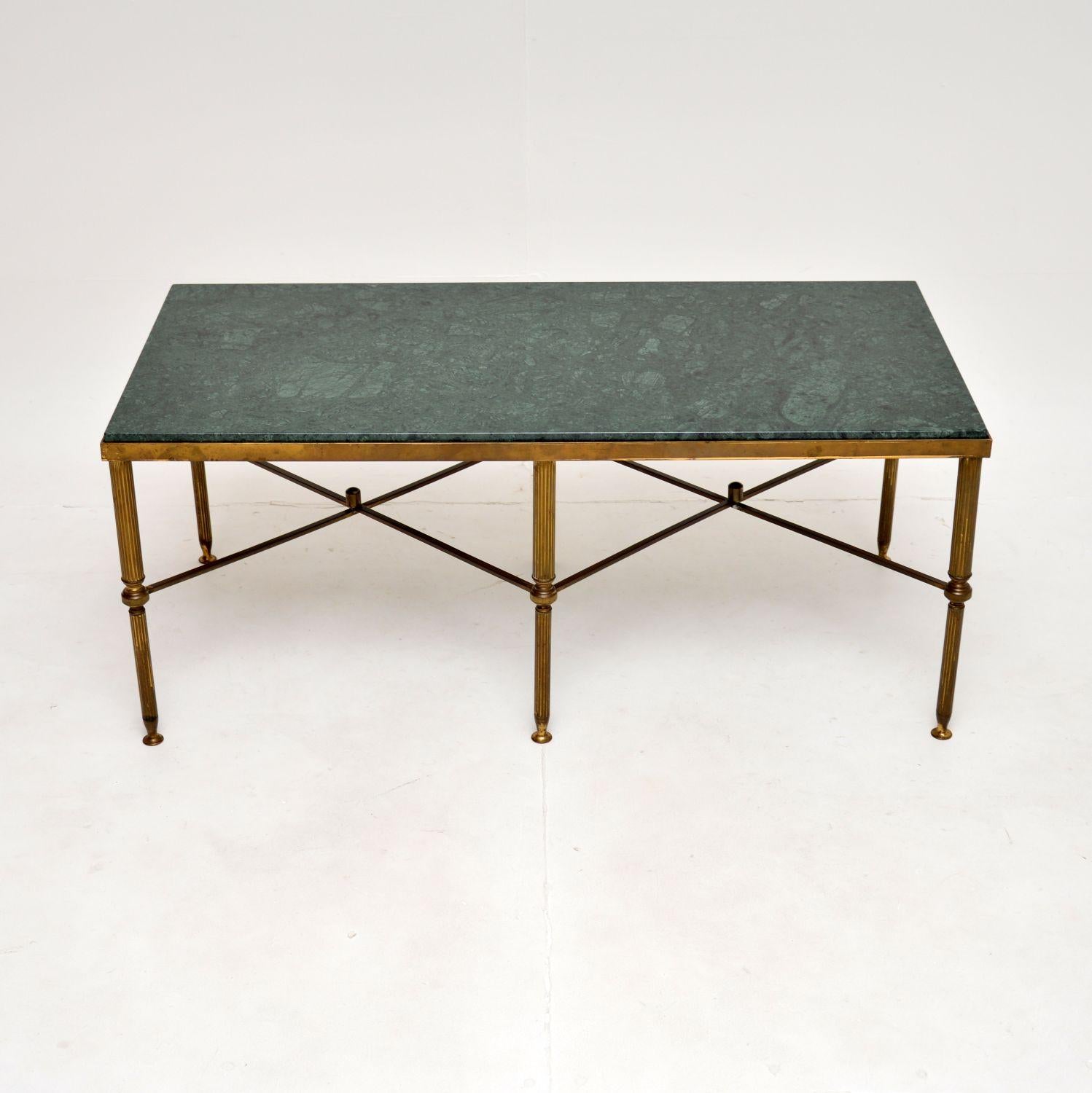 A stunning antique French marble top coffee table in brass. This was made in France, it dates from around the 1950’s.

It is of superb quality, the solid brass frame has a very beautiful and interesting cross stretchered design. The inset green