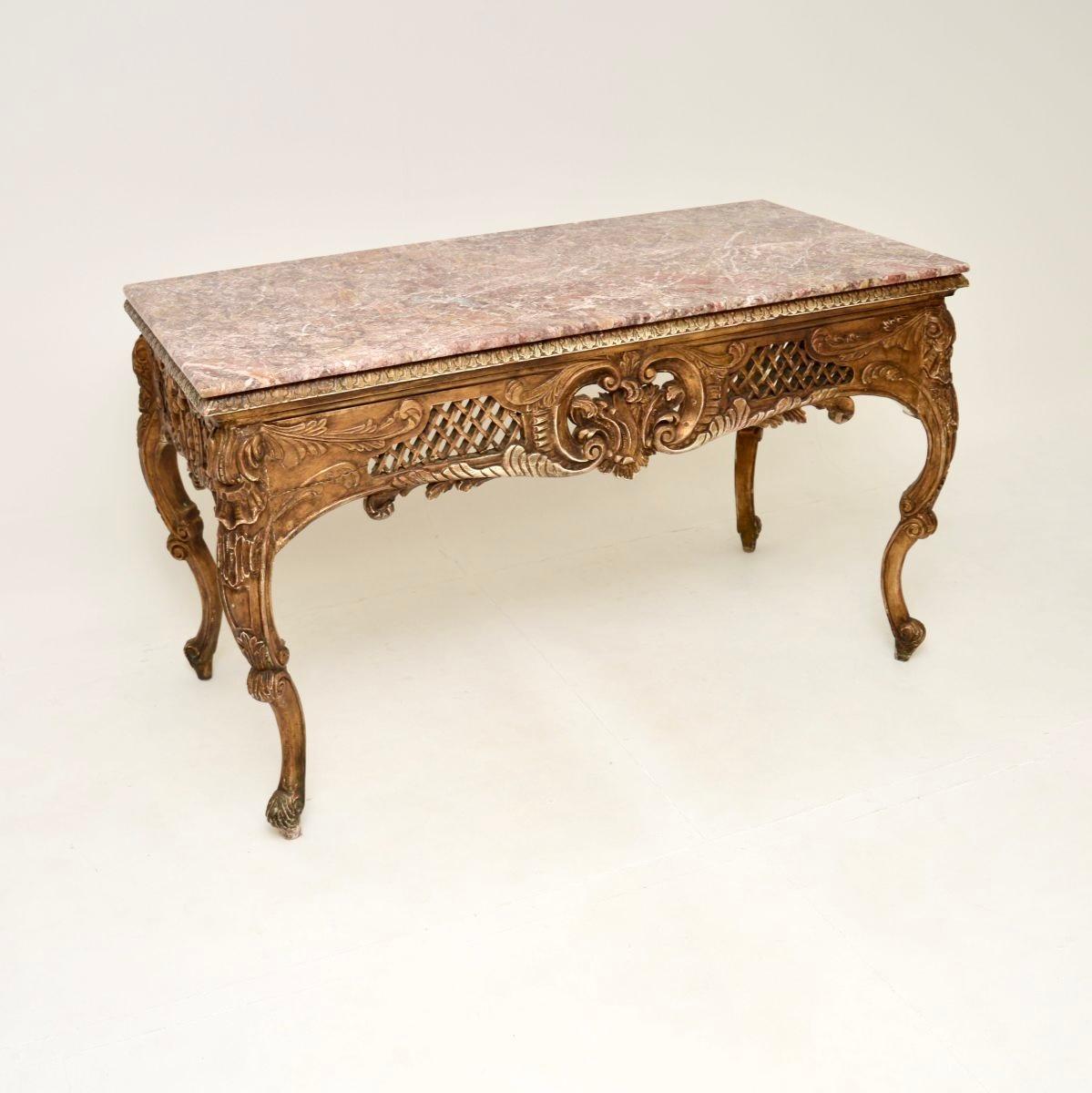 A large and impressive antique French marble top console / centre table. This was made in France, we would date it from around the 1890-1910 period.

It is of superb quality, with stunning carving throughout. It is a great size and is carved on all