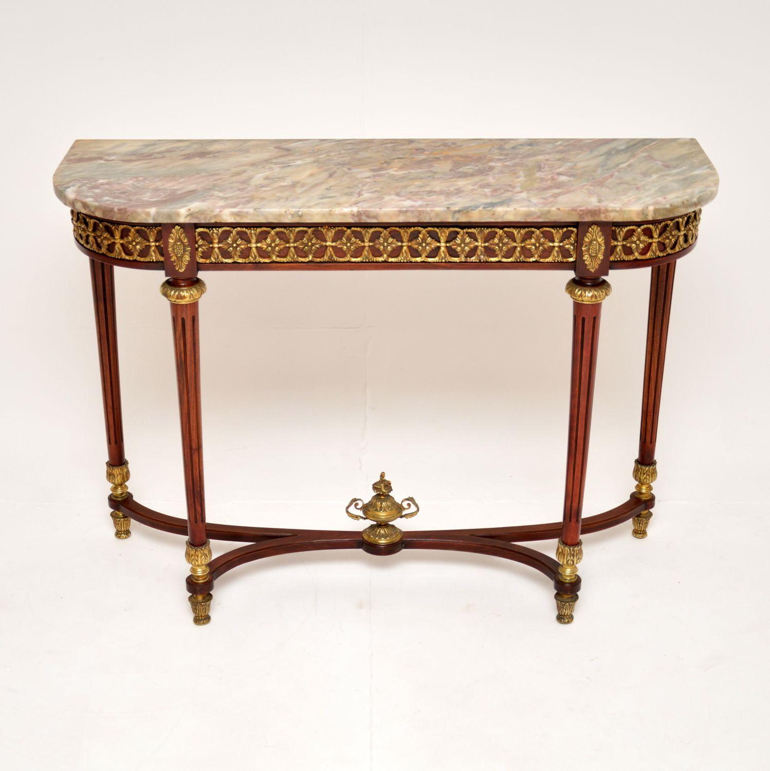 A beautiful antique French console table with a marble top. This dates from around the 1930’s.

It is of excellent quality, the frame is elegant and sturdy, with high quality gilt bronze ormolu mounts. The marble top sits loose on the base, it has