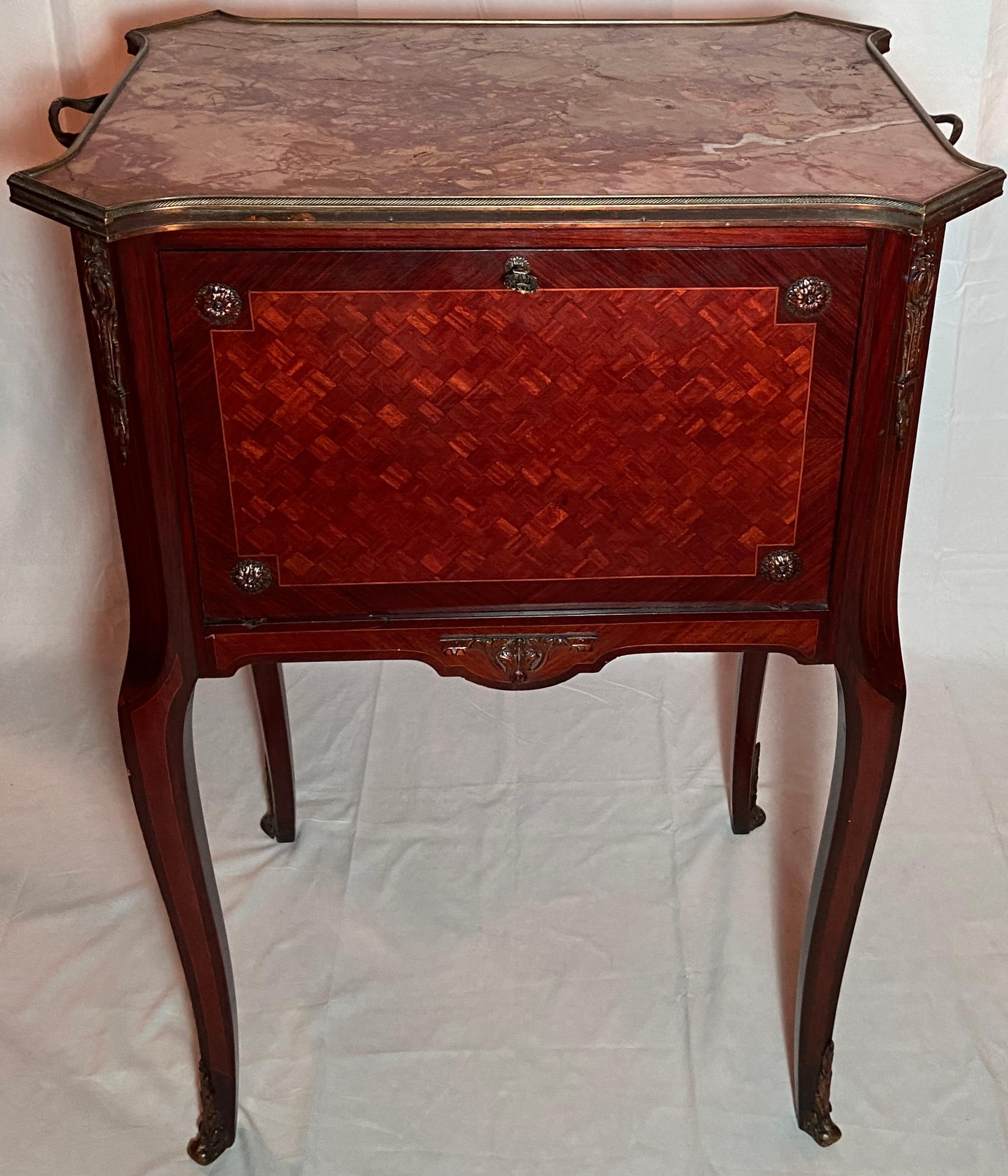 Antique French Marble-Top and Gold Bronze Mounted Mahogany Drinks Table, Circa 1890.
Handsome marquetry on front, glass sides and mirrored interior. 