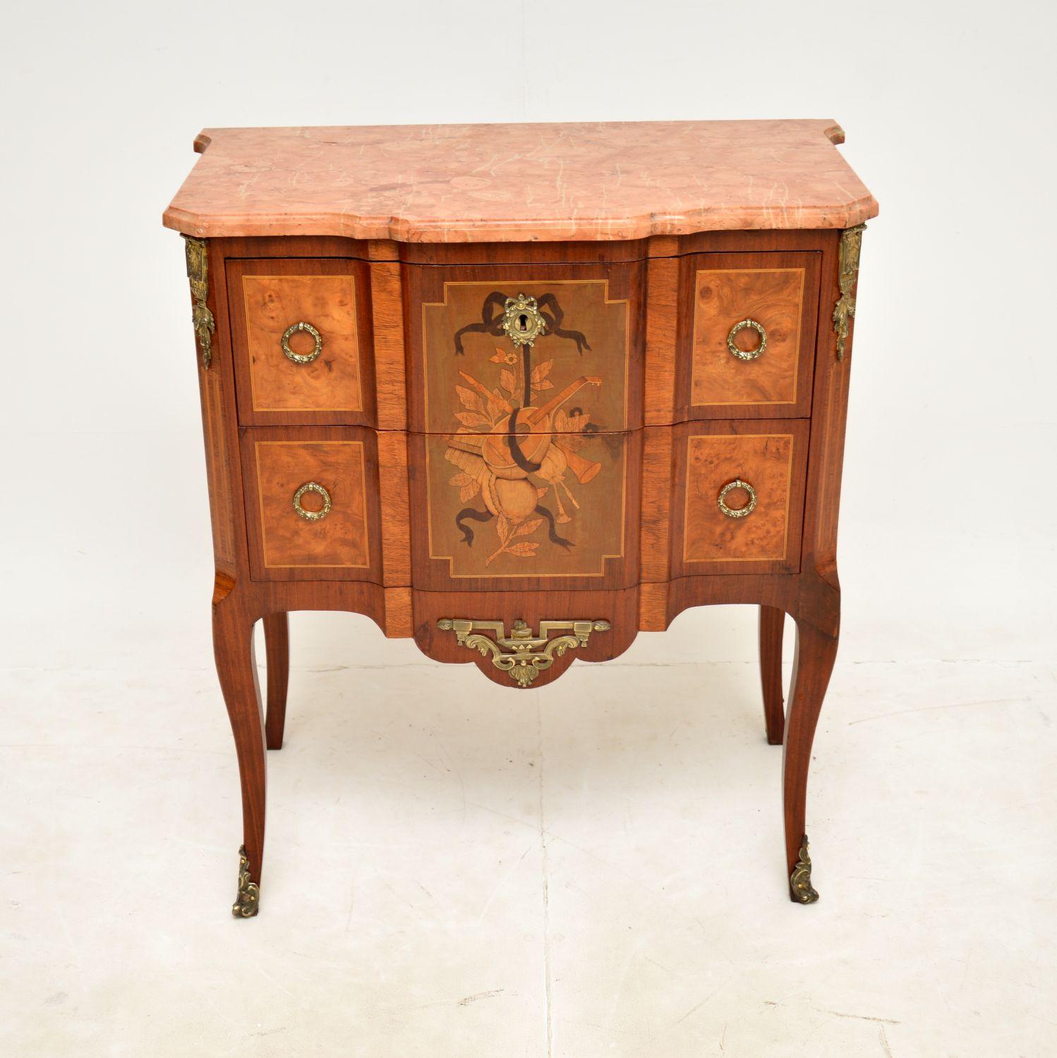 A stunning antique French commode with a marble top. This dates from around the 1880-1900 period.

It is of superb quality, it is predominantly burr walnut, with beautiful inlays of various woods and high quality gilt bronze mounts. The colour tones