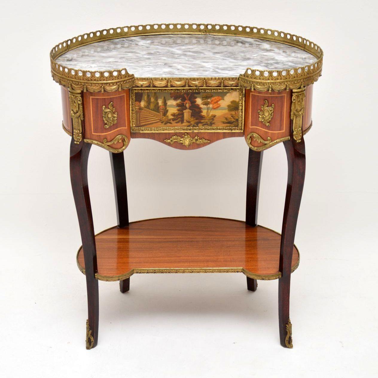 Antique French marble-top kidney shaped side table in good condition & with some fine details. The top has a pierced gilt metal gallery with swag decoration & there are many gilt bronze mounts with classical decorations all-over this table. There’s