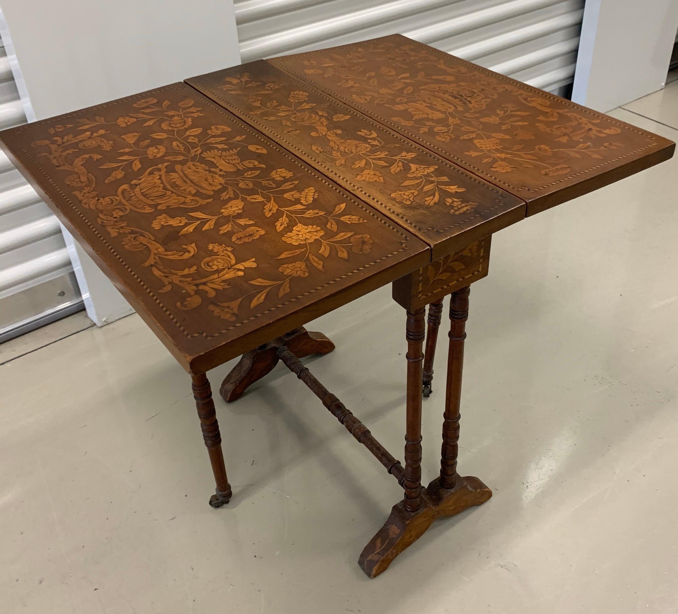 Expandable drop-leaf end table that can expand, when both leafs are in the up position, to be used as a
small card table or the like. This antique, circa late 19th century France, has full marquetry and measures just 5.5