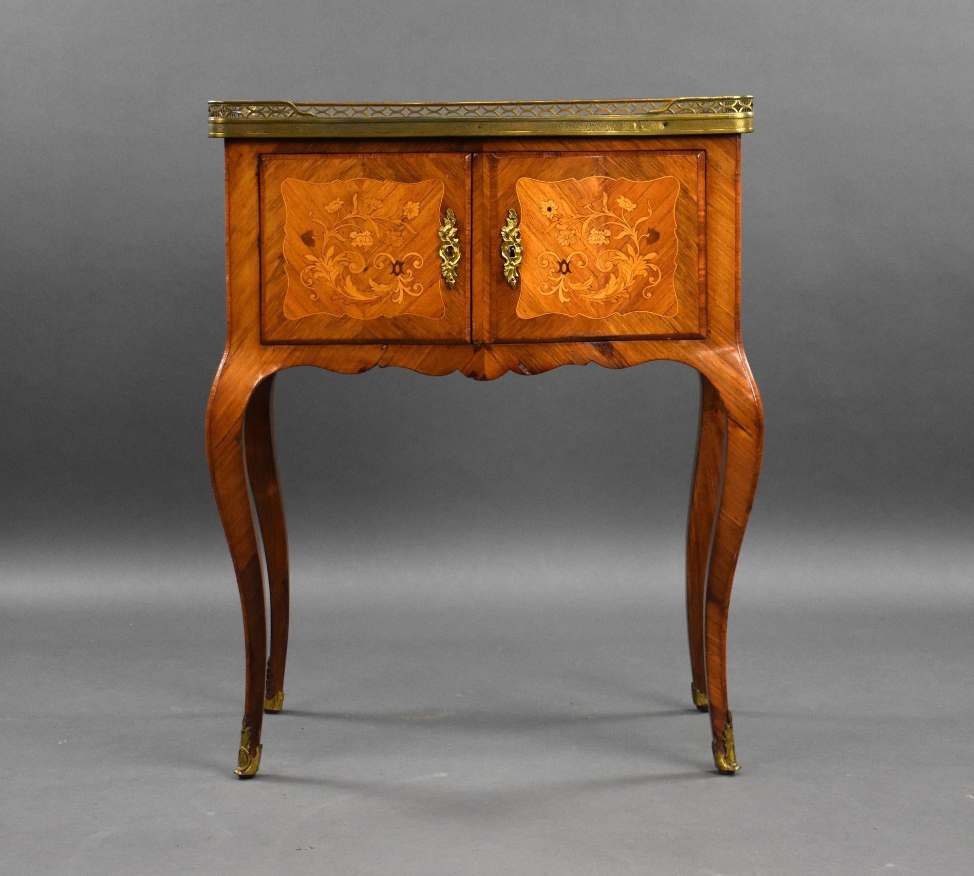 For sale is a good quality antique French marquetry side cabinet, of bowed form, with a three quarter pierced brass gallery, having a pair of marquetry inlaid cupboard doors below, standing on delicate cabriole legs. This piece remains in good