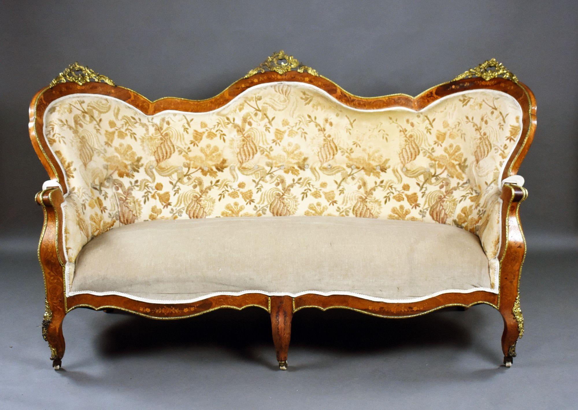 For sale is a good quality antique French marquetry sofa, the frame decorated with brass mounts and ornate marquetry inlay, standing on elegant legs terminating on original castors, the sofa remains in good condition, showing minor signs of wear
