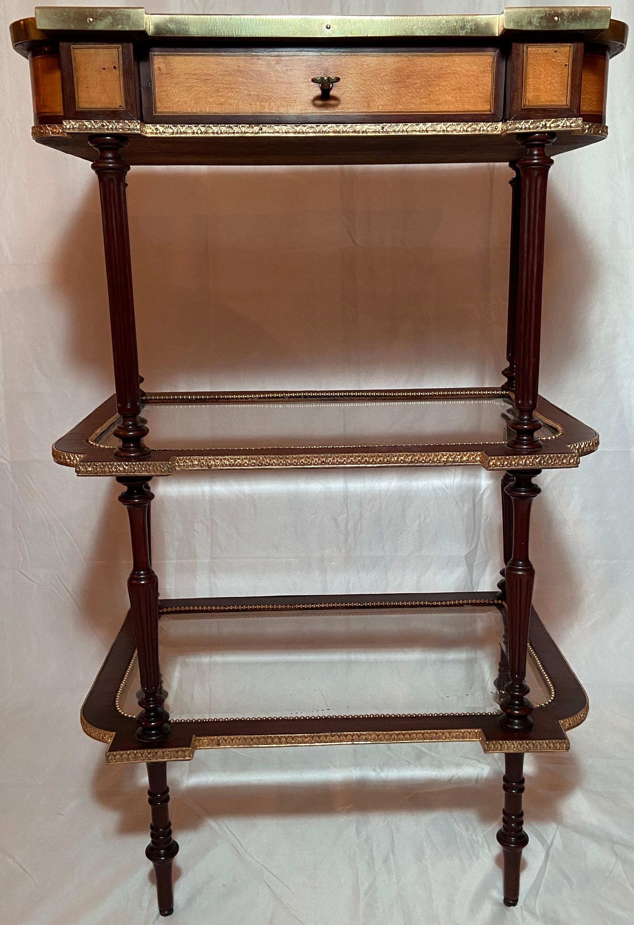 Antique French Marquetry table with Bronze D' Ore Mounts and glass shelves below.