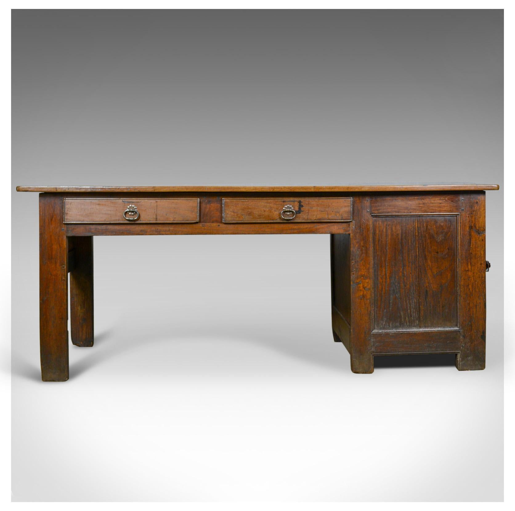 This is an antique French Mayoral clerk's desk. An oak and elm table dating to the mid-19th century, circa 1850.

A substantial and heavy French oak clerk's desk
The stout stocks of oak and elm displaying good color throughout
Of pegged
