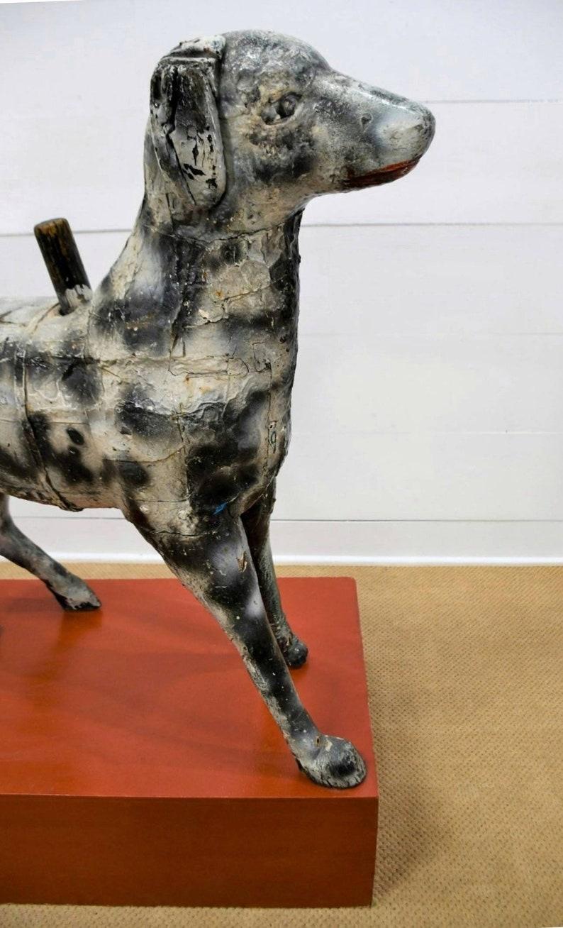 A scarce European antique hand carved and painted primitive French menagerie carousel dog. 

Hand-crafted in the late 19th / early 20th century, the large scale carnival fair / amusement park ride now fashioned as a one-of-a-kind folk art work /