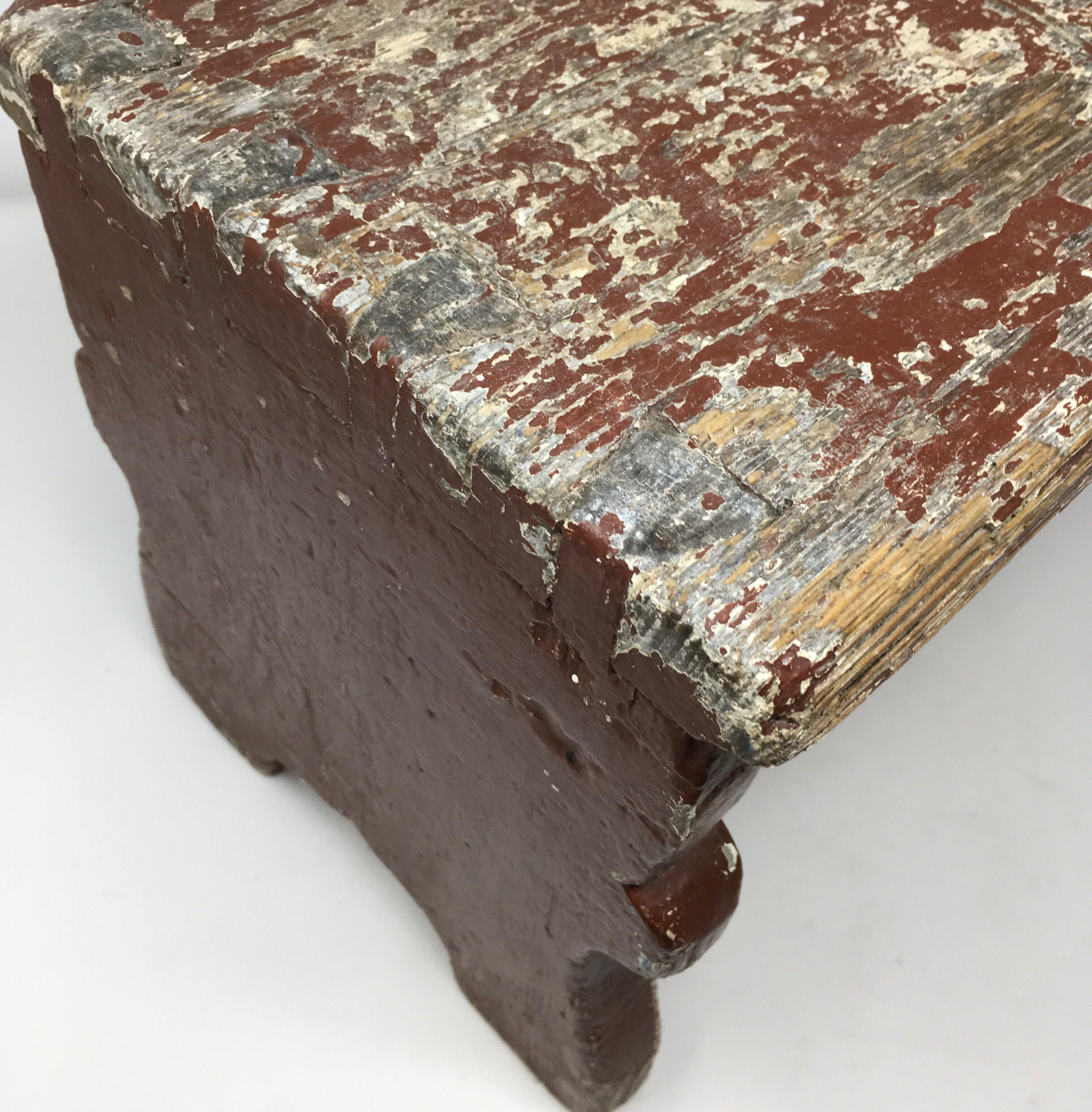 Found in the South of France, this antique French milking stool with aged patina and traces of original paint is made of solid hardwood with dovetail construction and bears a hand cut opening in the top for ease of carry. With its rustic charm,