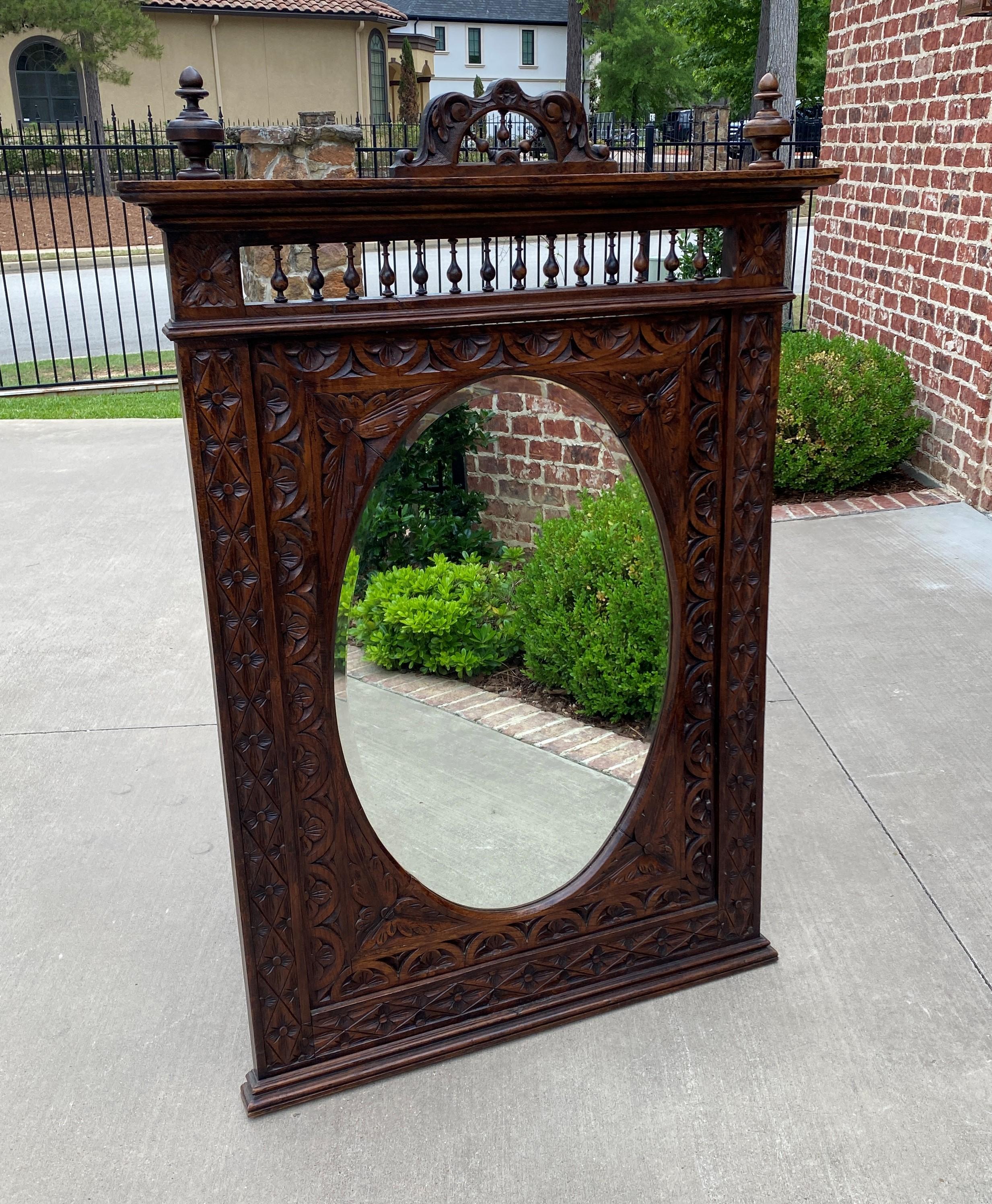 Beautiful antique French Breton oak highly carved framed beveled oval wall mirror ~c. 1890s

Traditional and timeless~~popular French Breton style with spindles and finials~~beveled mirror with highly carved frame with acanthus and floral