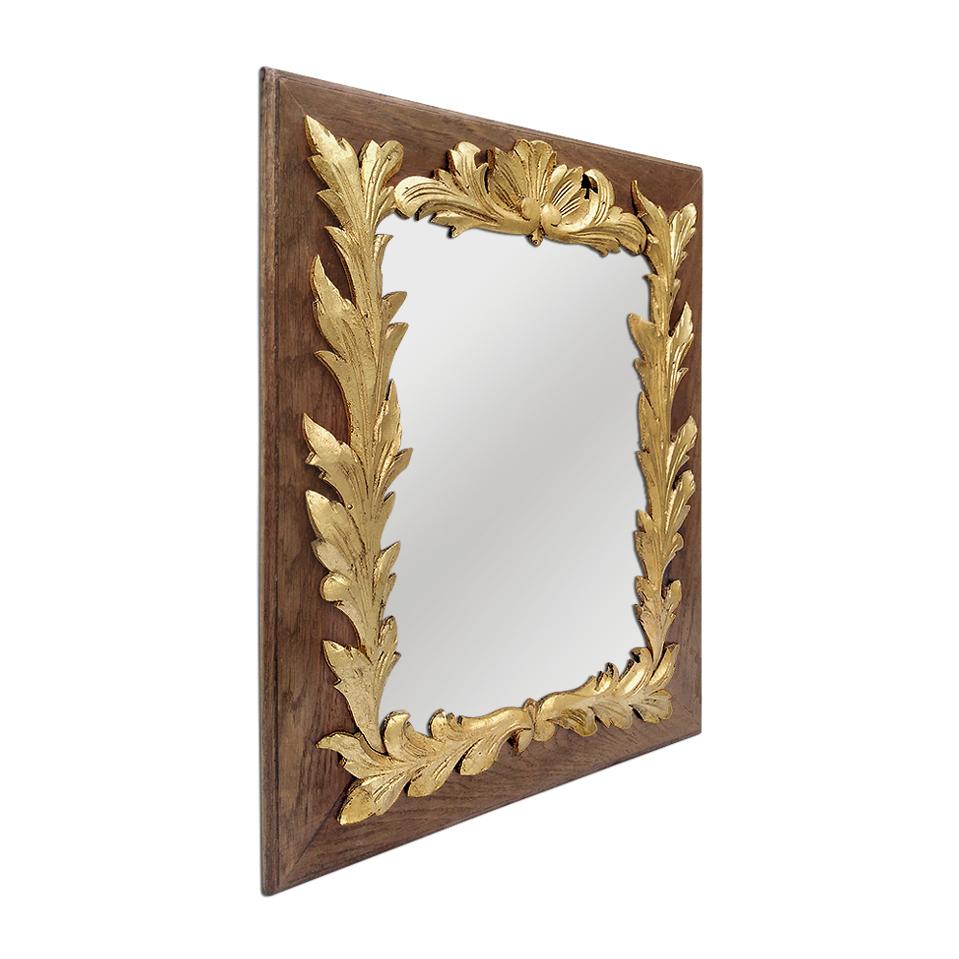 Antique oakwood French mirror decorated with stylized giltwood foliages around the antique frame, circa 1940. Re-gilding to the leaf patinated. Modern glass mirror. Antique frame width 11 cm / 4.33 in. Antique wood back.