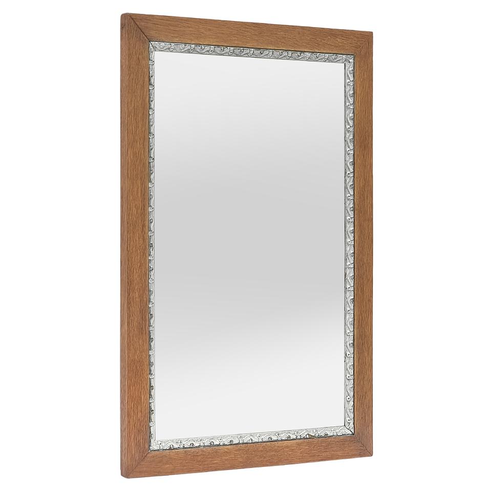 Antique French mirror in light oak wood from the 1950s with a silver leaf-patinated stylized frieze  on the edge of the glass mirror. Frame width: 5 cm / 1.96 in. Modern glass mirror. Wood back.