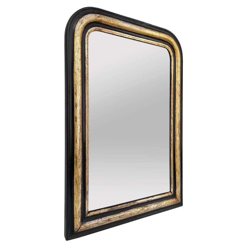 Antique wall mirror Louis-Philippe style (for the shape), Napoleon III period , circa 1880. Antique giltwood and black colors frame, stylized foliages engraved ornaments. Gilding to the leaf patinated by the time. (Antique frame width measures: 7.5