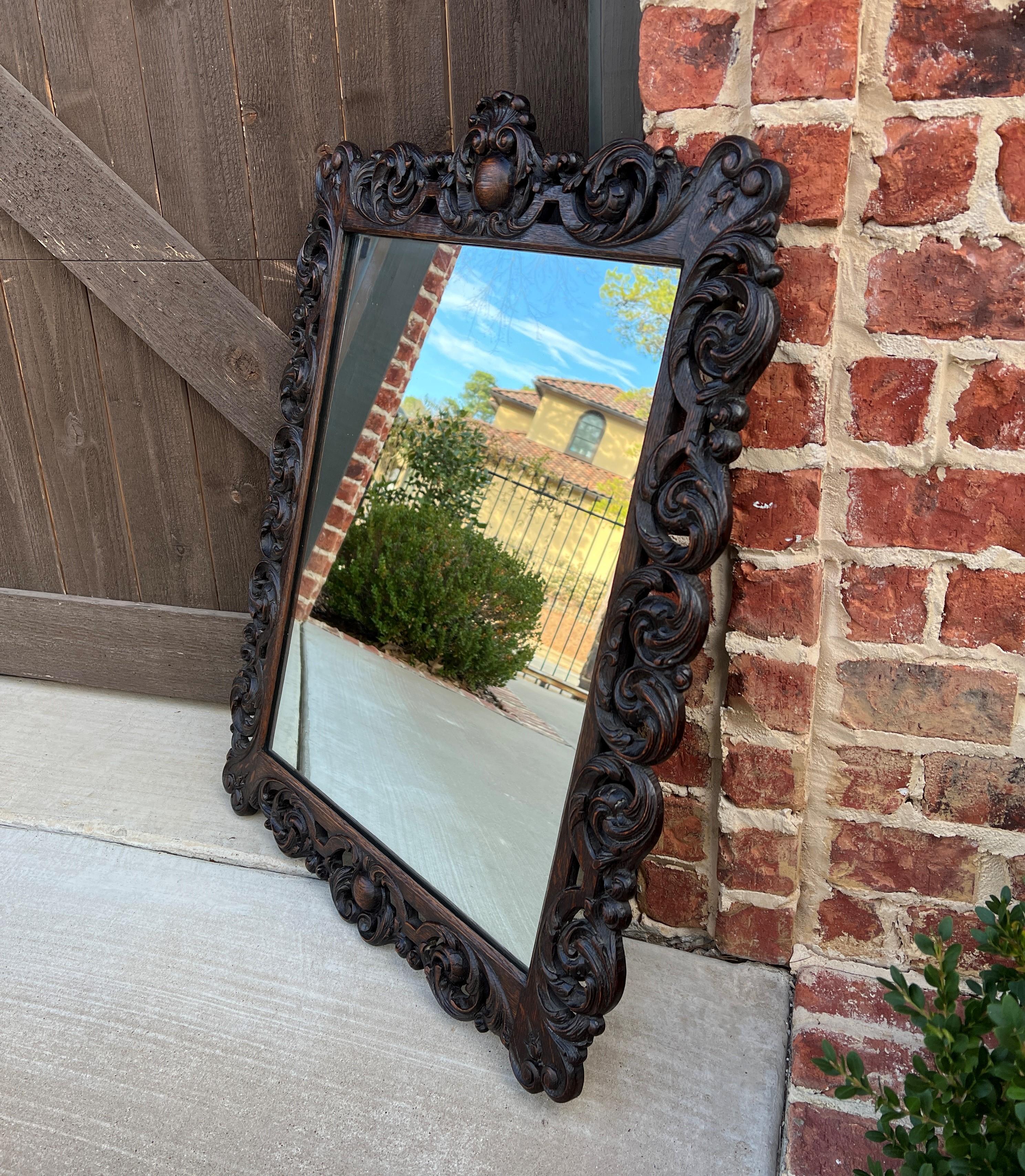 CHARMING Antique French Rectangular Framed Carved Oak Wall Mirror with Center Cartouche ~~c. 1920s-30s
 
Popular French classic framed mirror~~perfect for an entry hall or powder room or just about any room in the house

Versatile size

Frame is