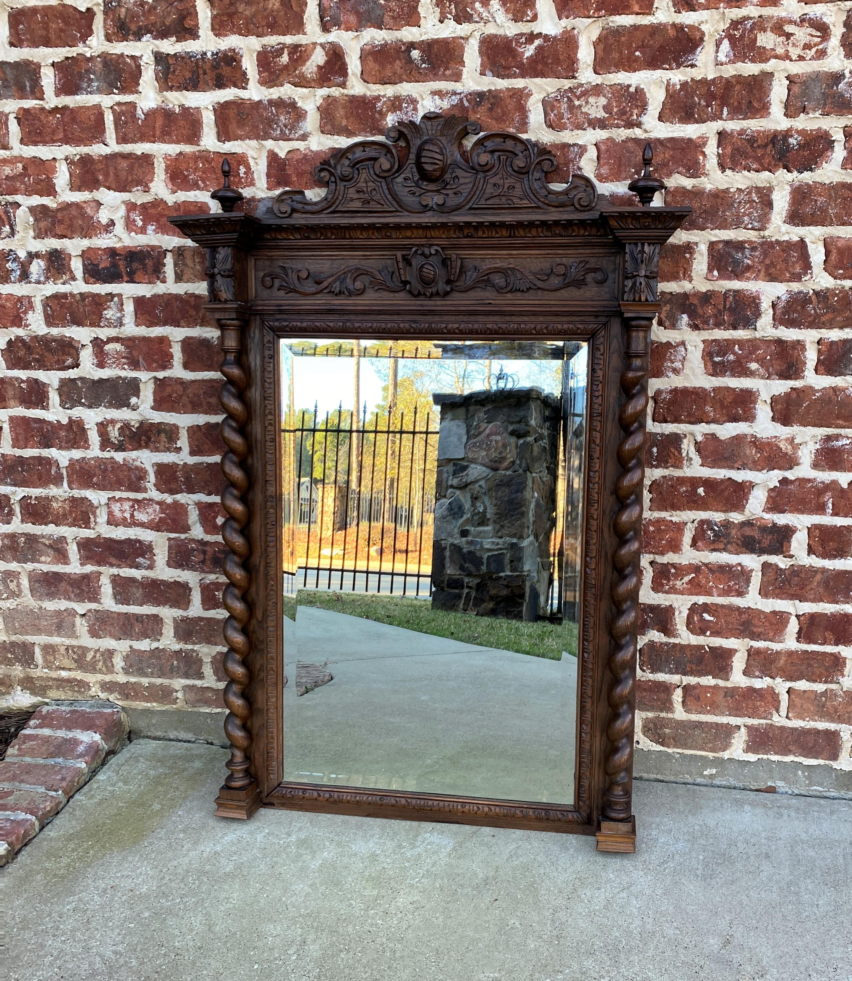 Exquisite antique French carved oak large framed rectangular beveled wall pier mantel mirror~~barley twist posts~~c. 1880s
 
Popular Renaissance Revival style~~traditional and timeless~~large mirror with 1.25