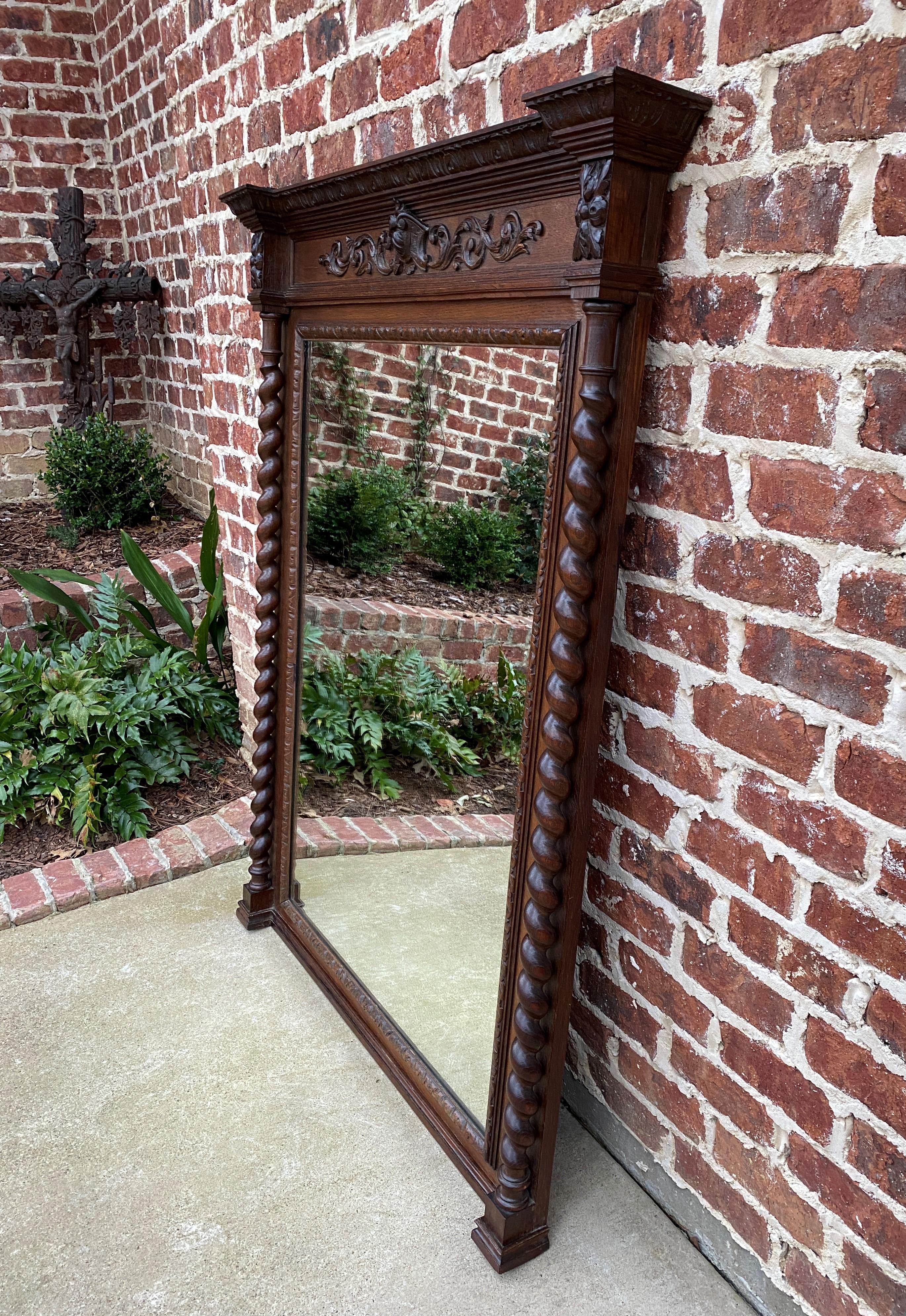 Exquisite antique French carved oak large framed rectangular wall pier mantel mirror~~Barley Twist Posts~~c. 1920s
 
Popular Renaissance Revival style~~traditional and timeless~~Large mirror with carved acanthus and cartouche frame with 