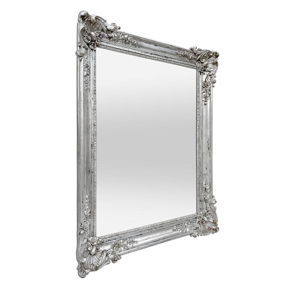 Antique French mirror silver wood with Louis XV style shells decorations, circa 1890. Decor of flowers and foliages stylized on the antique frame (frame width: 7.5 cm / 2.95 in.). Re-gilding to the leaf. Modern glass mirror. Antique wood back.