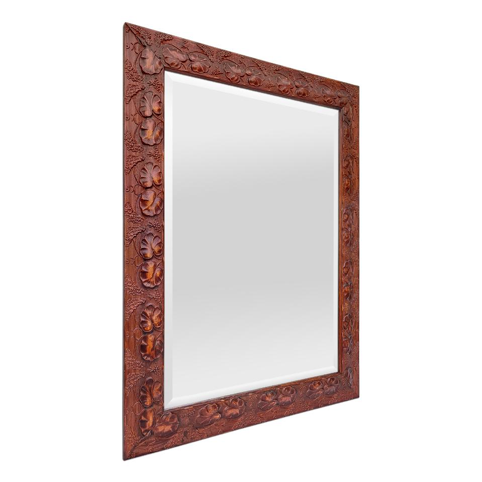 Antique French frame mirror from the '80s in stucco imitating carved wood, decorated with a duo of stylized leaves in autumn colors (red-brown, ochre). Antique frame width: 8 cm / 3.14 in. Modern mirror in bevelled glass. Wood back.