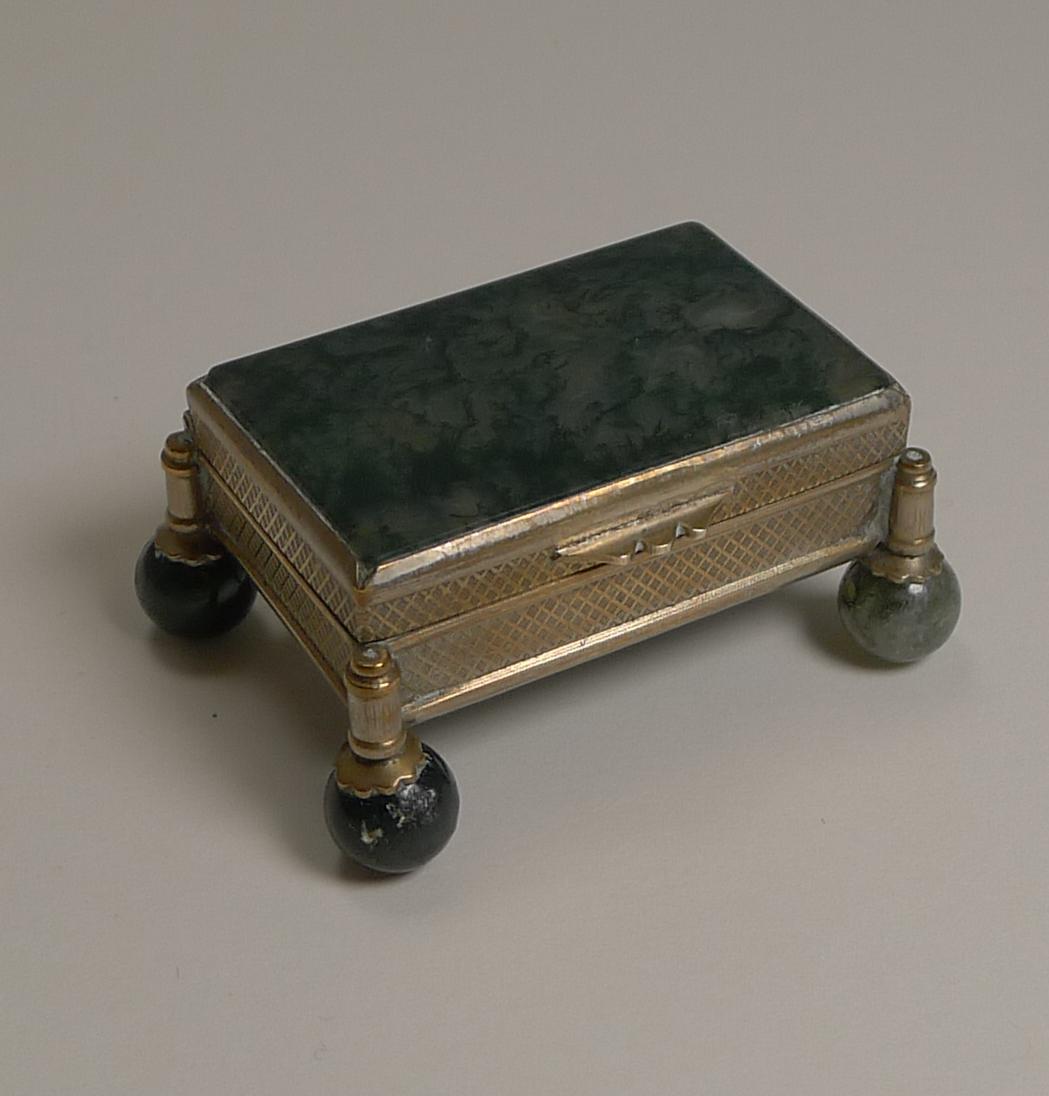 A delightful small moss agate box standing on it's four original agate ball feet.

The hinged lid opens to reveal an agate box, the stone without cracks.

Excellent condition with a footprint measuring 2 1/4
