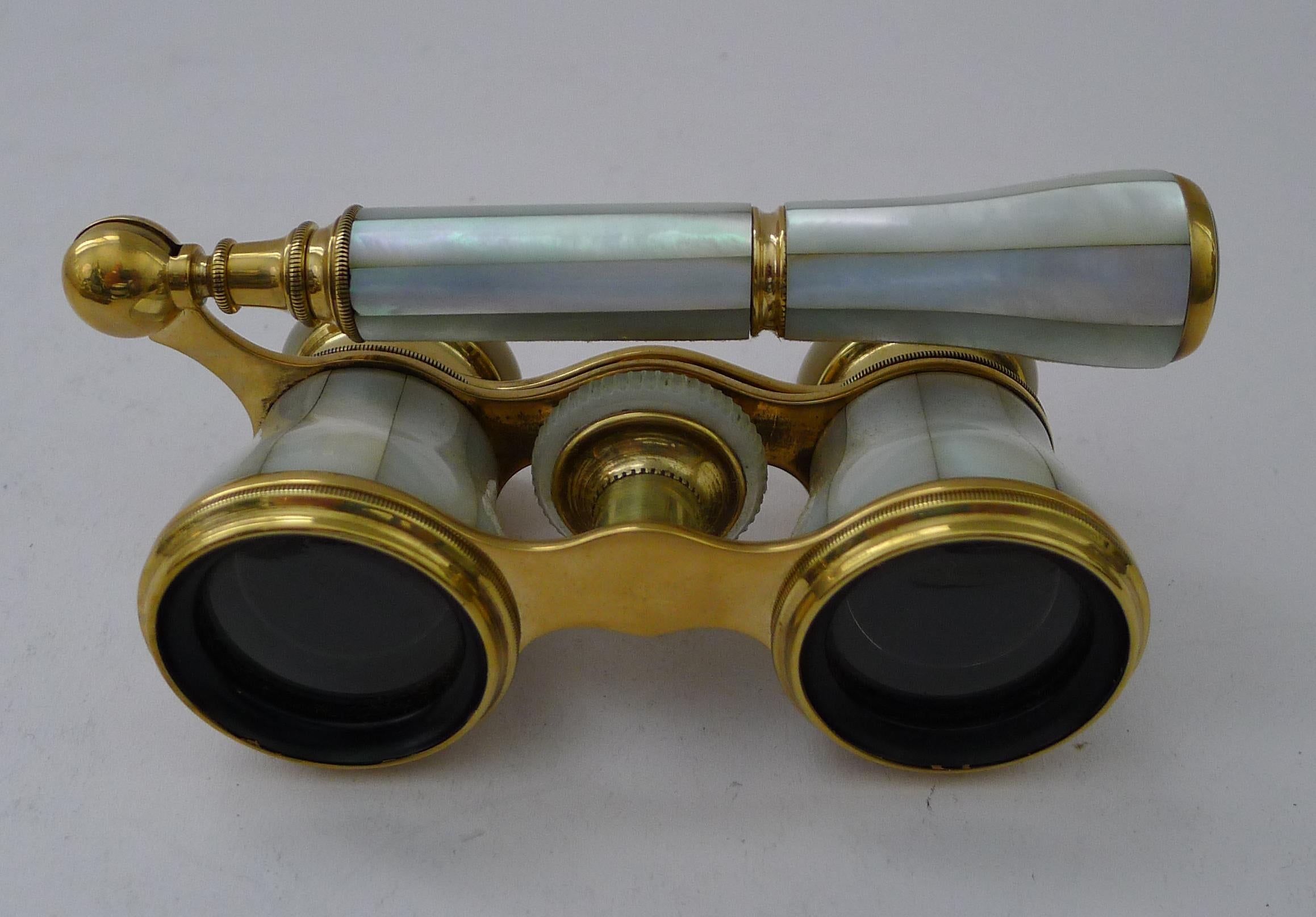 A splendid pair of Edwardian Opera / Theatre glasses professionally re-polished to gleam, making them as good as they would have looked over 100 years ago.

This is a pair with a telescopic lorgnette handle. All is wrapped in wonderful Mother of