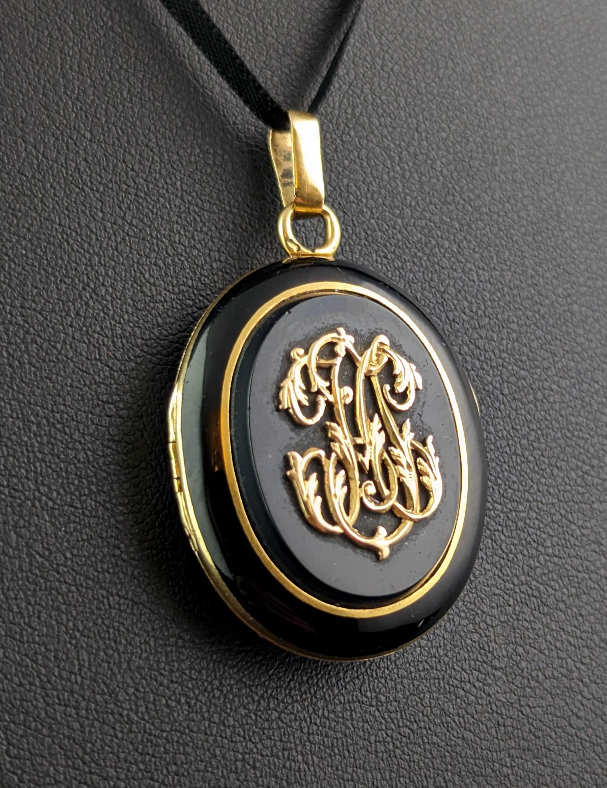 This stunningly sentimental mourning locket is not one to be missed.

Rich, smooth and glossy, inky black onyx contrasts wonderfully with the rich 18ct yellow gold.

It has chunky onyx panels front and back with a decorative gold monogram to the