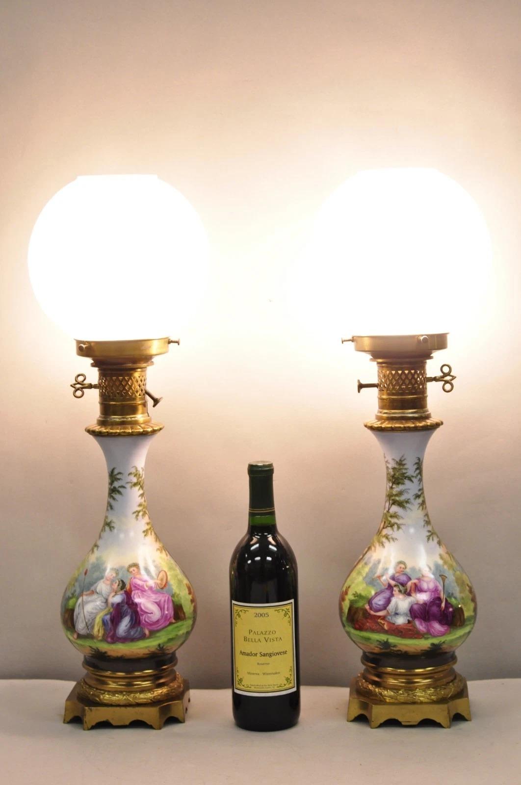 Antique French Napolean III Style Hand Painted Porcelain Converted Oil Lamp Electrified Table Lamps - a Pair. El artículo presenta escenas pintadas a mano de doncellas en la parte delantera y casas de campo francesas en la trasera, elevadas sobre